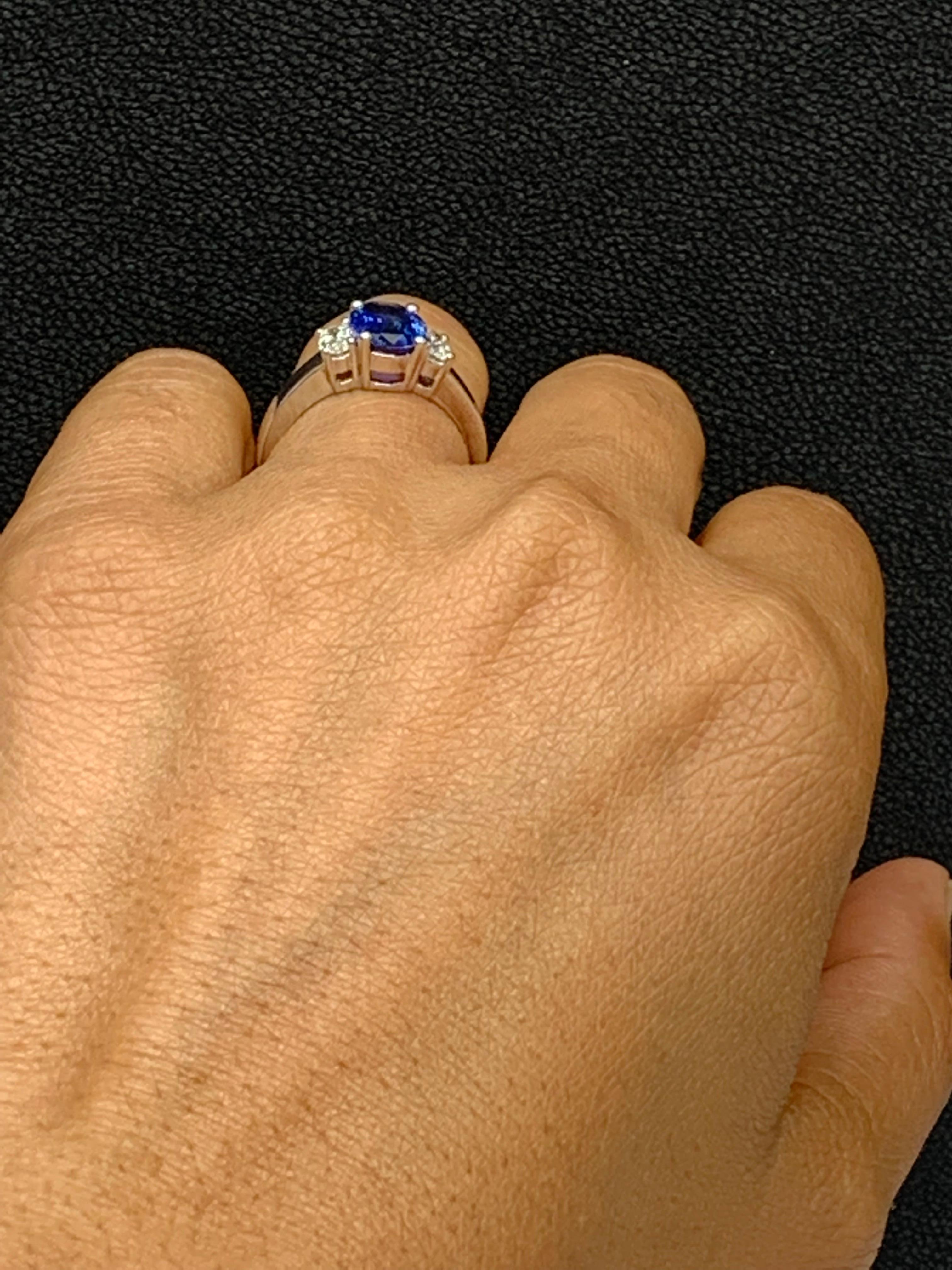Showcases an Oval cut, Vibrant color blue sapphire weighing 2.12 carats, flanked by two brilliant oval cut diamonds weighing 0.48 carats. Elegantly set in 18k White Gold.