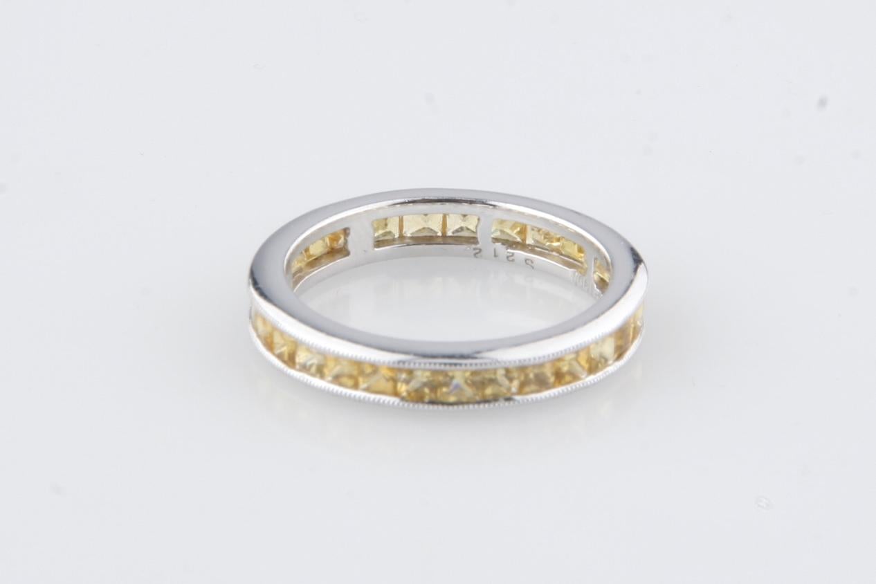 Gorgeous, unique eternity band
Features channel-set princess cut yellow sapphires in a ring
Platinum setting w/ milgrain border
Width of Band = 3 mm
Total Sapphire Weight = 2.12 ct
Total Mass = 3.7 grams
Size 6
Gorgeous Gift!