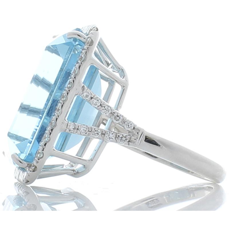 This ring is bold, and it is fabulous! The ring features a stately 21.27 carat - 19.13 X 15.41 millimeter emerald cut aquamarine that is accented by glittering bright white diamonds that total 1.01 carat. Its color is highly-prized and exactly you