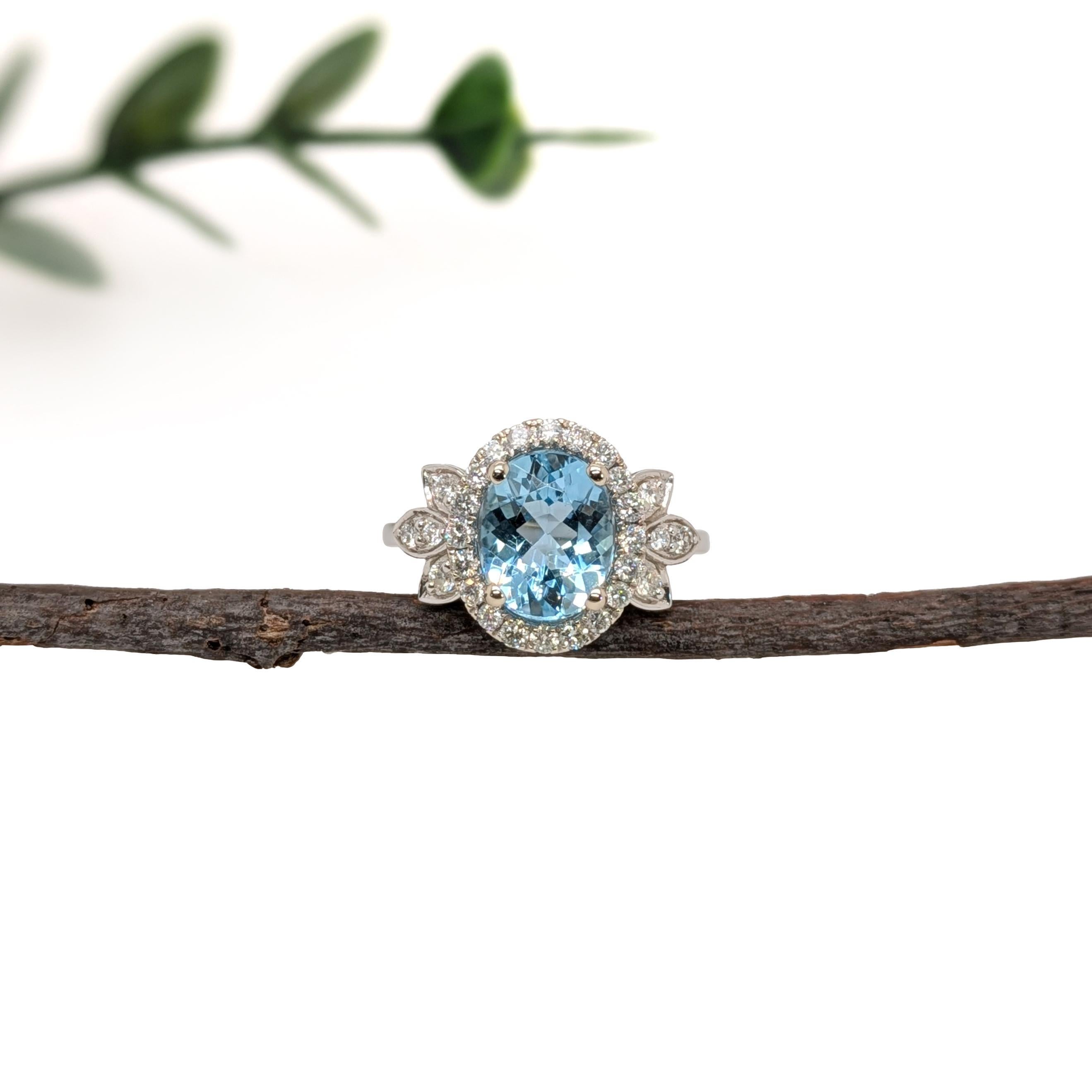 This stunning 2.12ct Santa Maria Aquamarine Ring is set in solid 14K white gold, showcasing a beautiful 10x8mm oval-shaped aquamarine. The aquamarine is surrounded by 28 natural diamonds, totaling 0.49cts, adding a touch of brilliance and