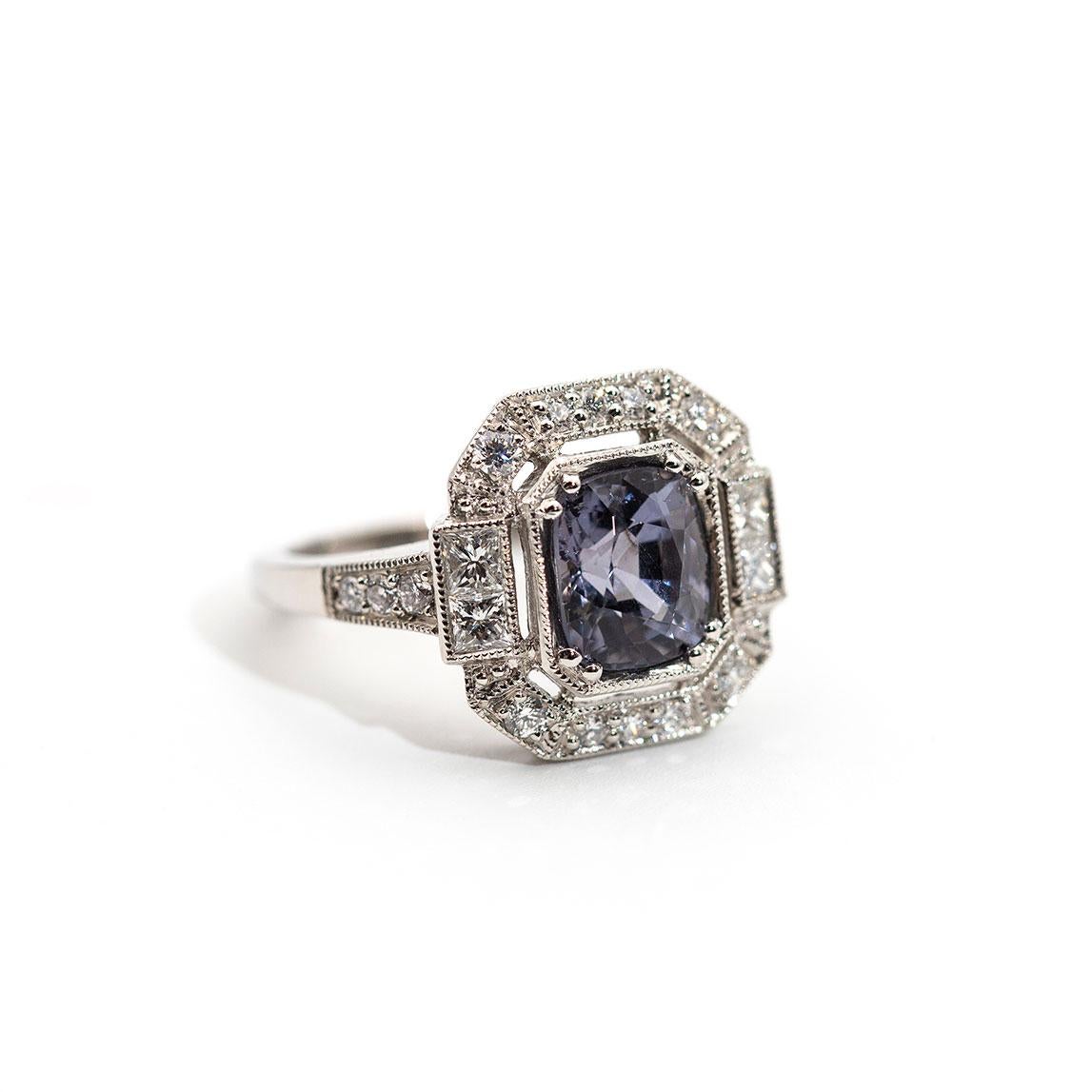 This ring is forged in platinum and boasts a heart-stopping bright 2.13 carat greyish purple cushion cut spinel encompassed by 0.58 carats of sparkling round brilliant cut diamonds and princess cut diamonds. We have named this alluring beauty The