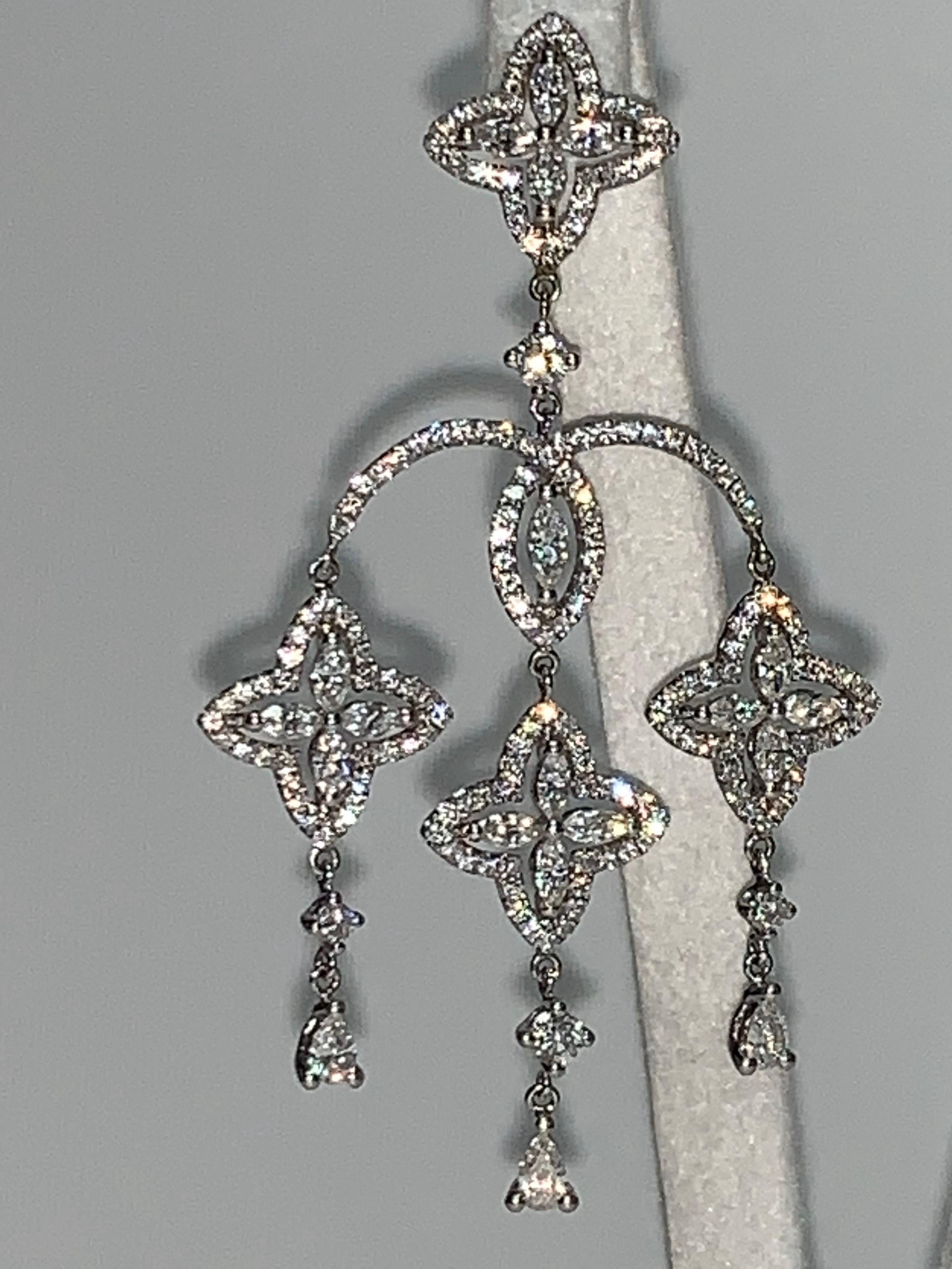 White Diamond, White Gold Earrings. 

Featuring an exquisite pair of White Diamond Earrings with a total weight of 2.87 carats: Pear Shape Diamonds; accented with Round Brilliant Cut Diamonds; set in 18K White Gold.

Diamonds, F in color and VS2