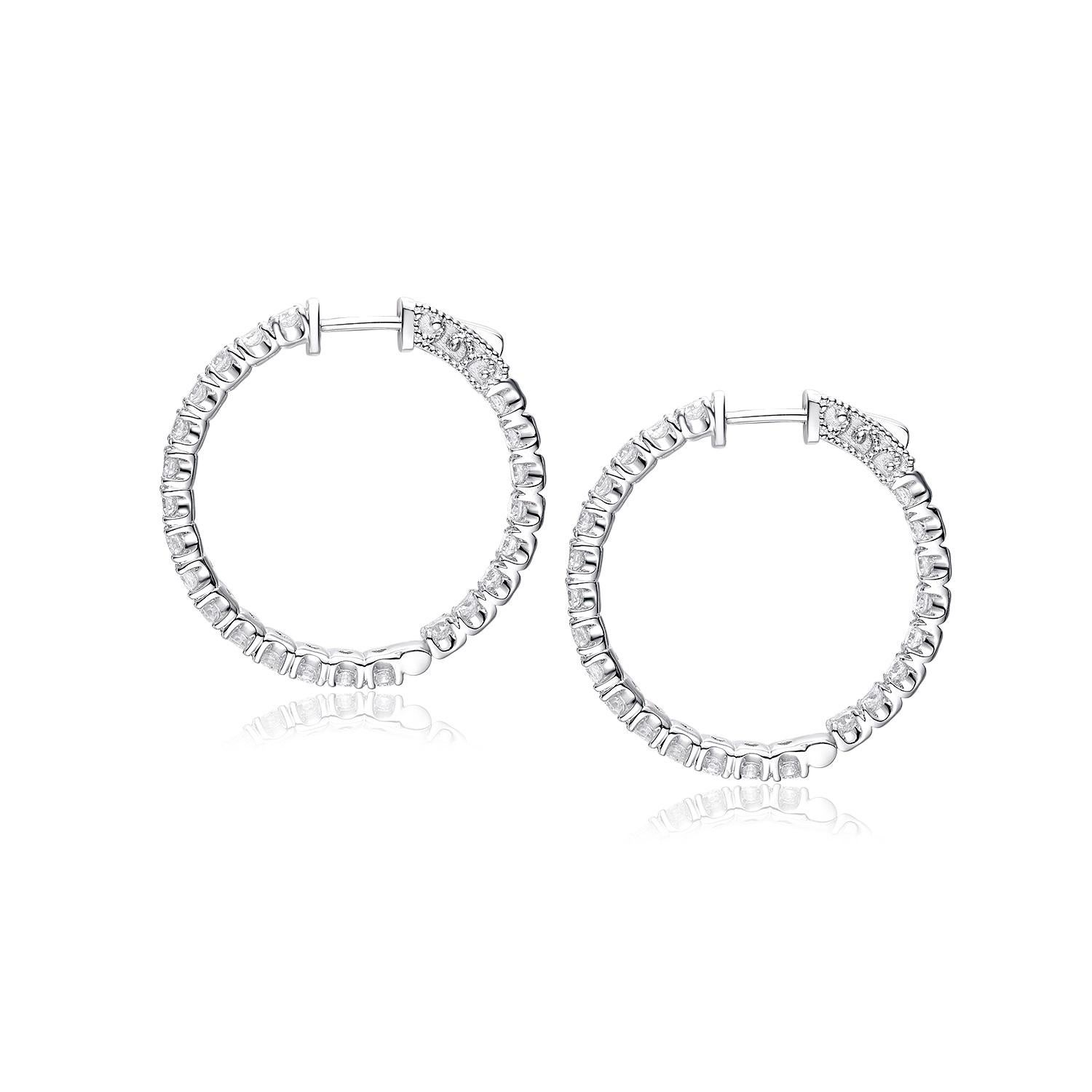These elegant hoop earrings are crafted from 18K yellow gold, offering a classic and warm aesthetic. Each earring is embellished with a generous array of diamonds, totaling 2.13 carats, that encircle the hoop in a continuous loop of radiance.

The