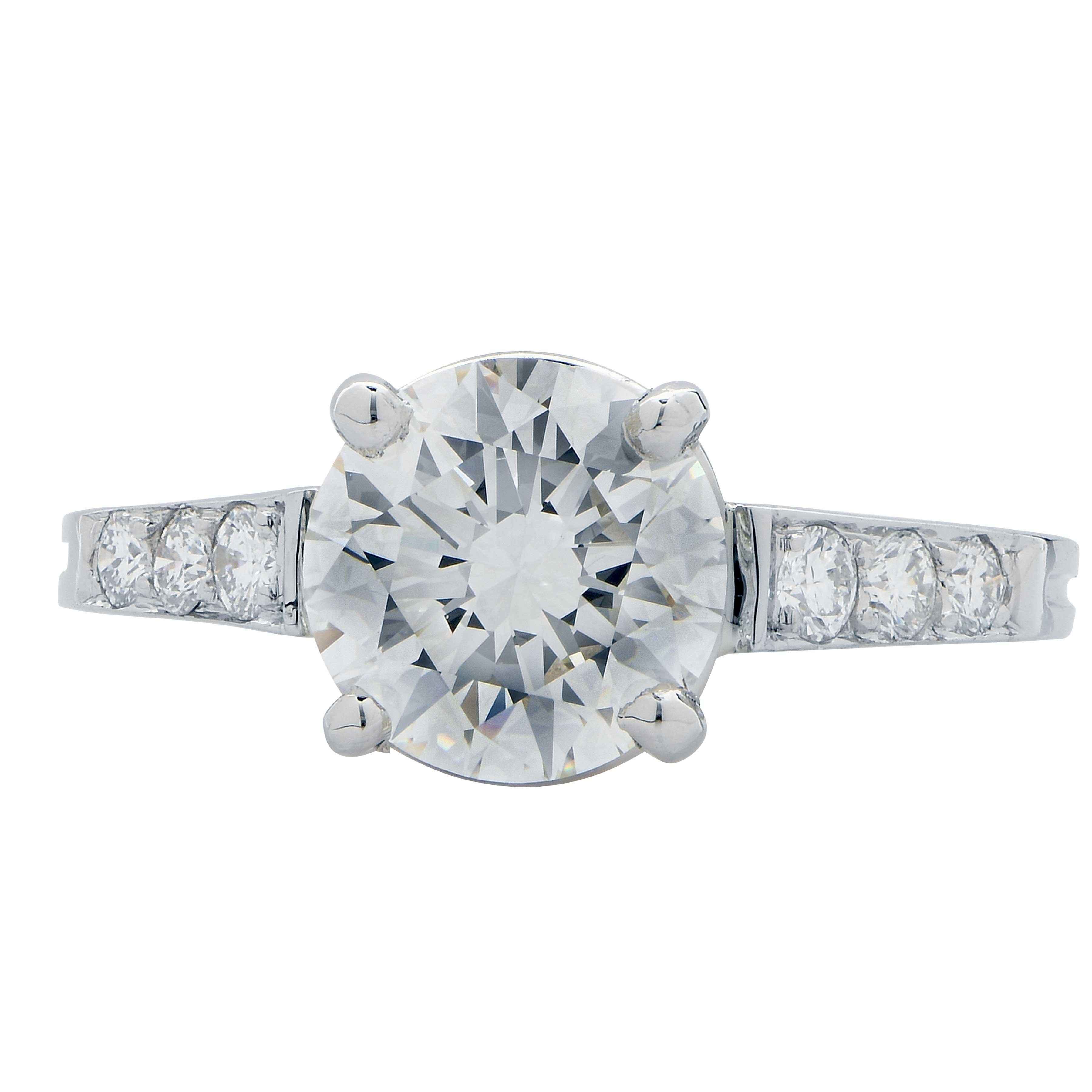 2.13 Carat GIA Graded H Color, VVS2 Clarity, Round Brilliant Cut Diamond set in platinum mounting with six round brilliant cut diamonds with an estimated weight of 1 ct. This beautiful and classic engagement ring is bright and full of life.
Ring