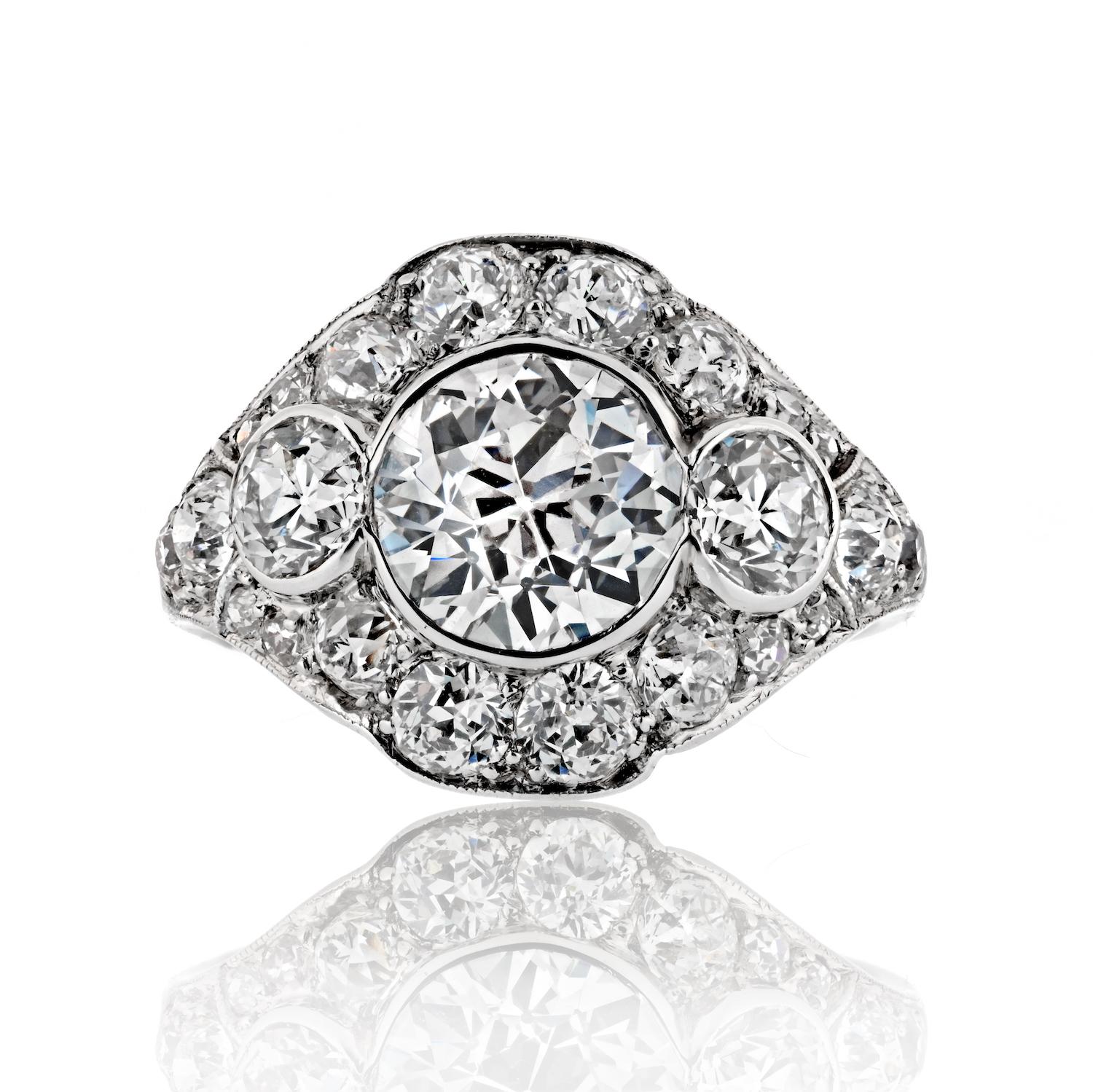 Elevate your style with our Art Deco Platinum Three Stone Diamond Engagement Ring, a breathtaking blend of vintage charm and timeless sophistication. This exquisite ring is meticulously crafted in platinum, showcasing a trio of dazzling diamonds