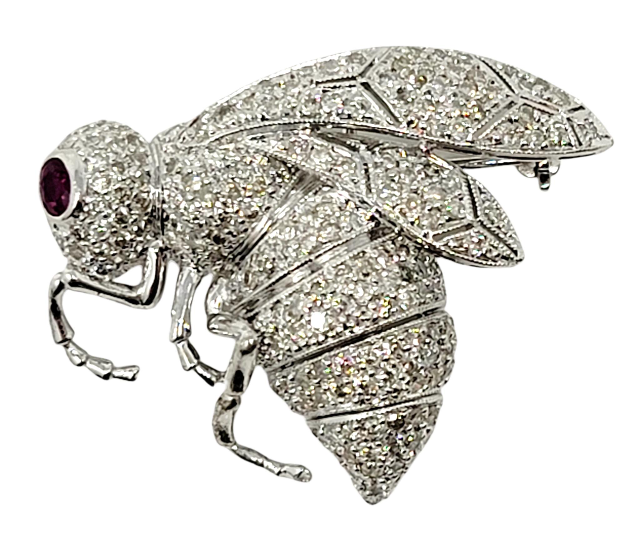 Stunningly detailed insect brooch filled with glittering diamonds and a single natural ruby. Unique, life-like design with articulated stinger. 

Type: Brooch
Metal: 18K White Gold 
Natural Diamonds: 2.00 ctw 
Diamond cut: Round Brilliant
Diamond