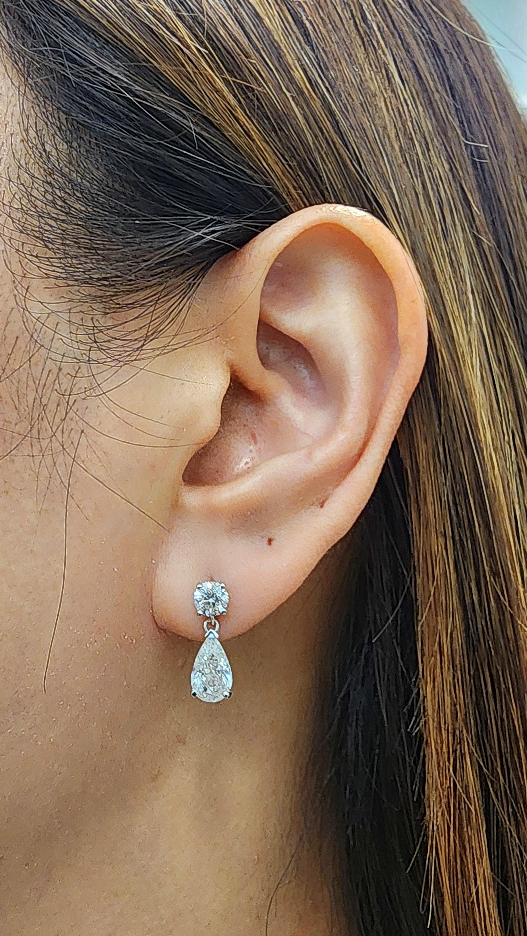 Questi eleganti orecchini a goccia presentano circa 1,09 ct. di diamanti bianchi con taglio a pera, colore G/H e purezza SI1/SI2, incastonati in oro bianco 14k. Completati da circa 1,04 ct. di diamanti bianchi a taglio rotondo, questi orecchini