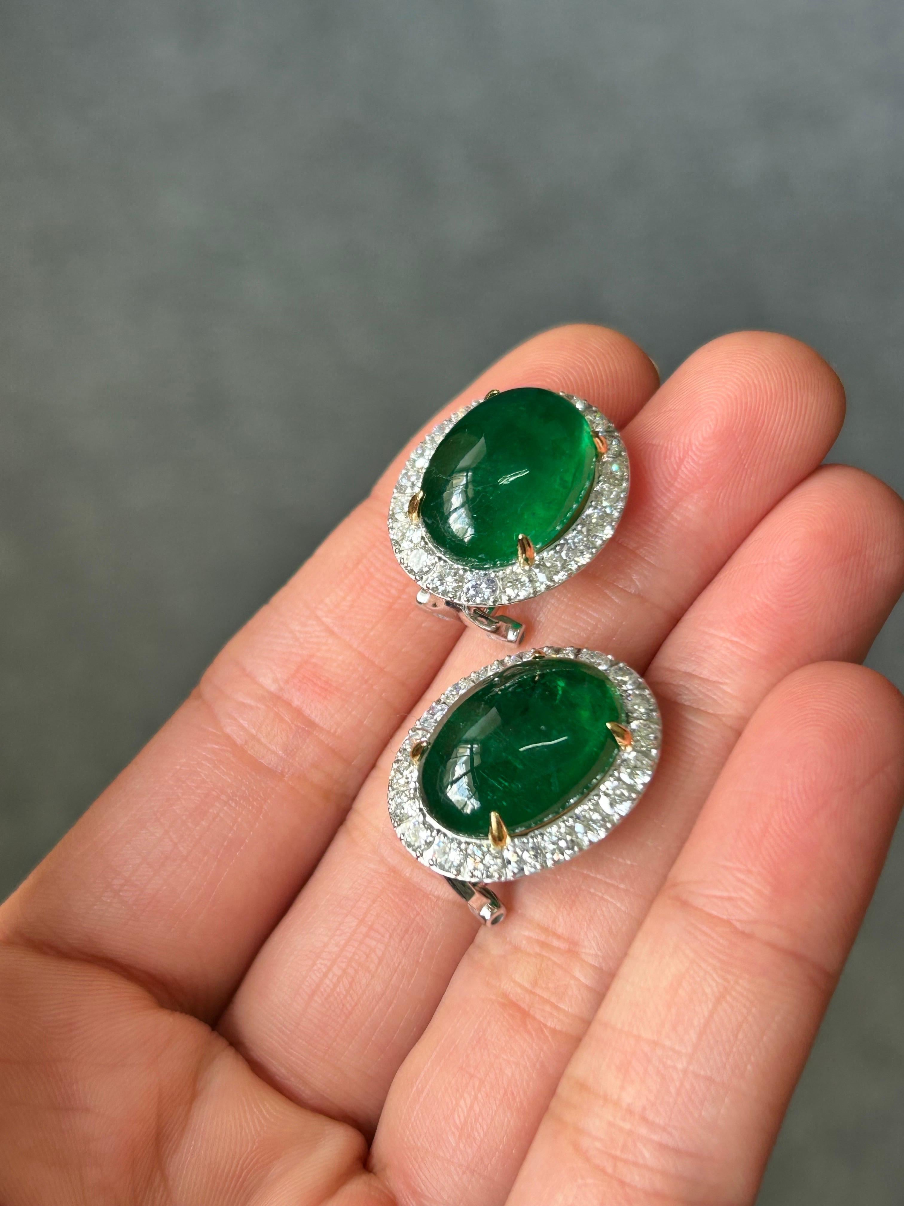 Zambian Emerald Cabochon outlined with Brilliant Cut Diamond Studs, with omega clip and 18K White Gold. Stunning center stones, with great luster and vivid green color. 

Center Stone Details: 
Stone: Zambian Emerald
Cut: Cabochon, Oval
Weight: