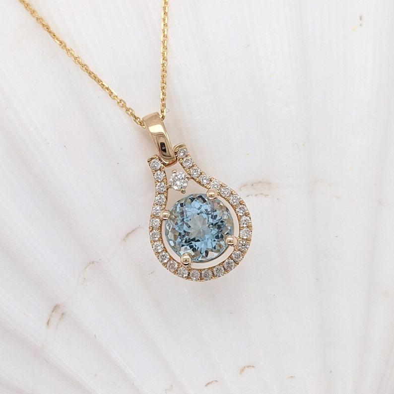Specifications:

Item Type: Pendant
Stone Specs:
Type: Aquamarine
Treatment: Heated
Hardness: 7.5-8
Shape: Round
Size: 8mm
Weight: 2.13 cts
Metal: 14k/1.71 grams
Diamonds S/I GH: 28/0.29cts
Sku: AJP001/1939

This pendant is made with solid 14k Gold