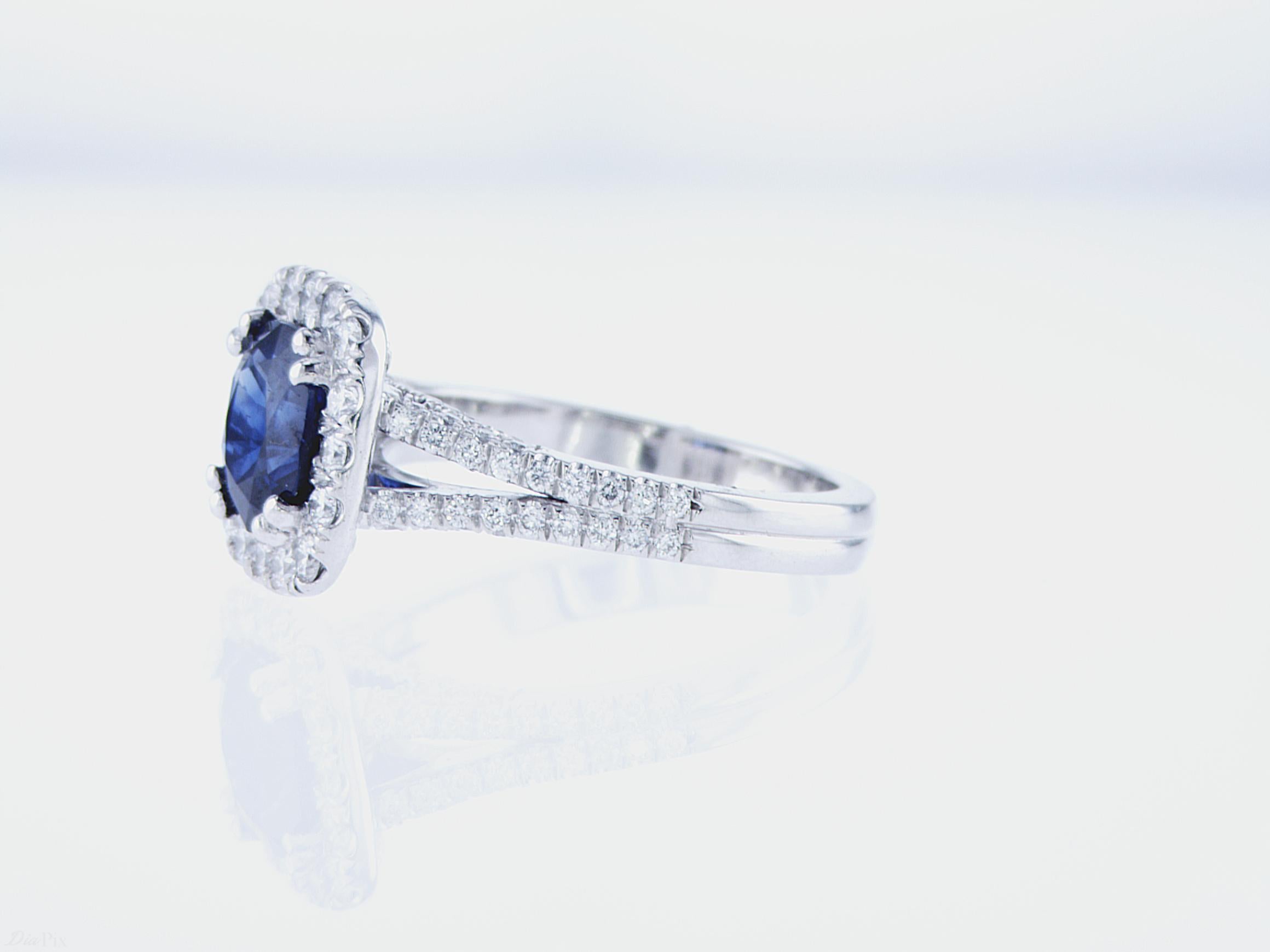 2.13ct Cushion Sapphire Cocktail Ring featuring 0.90ct Total Weight of Round Brilliant Diamonds, G/H Color, VS Clarity, in a Platinum Mounting.
