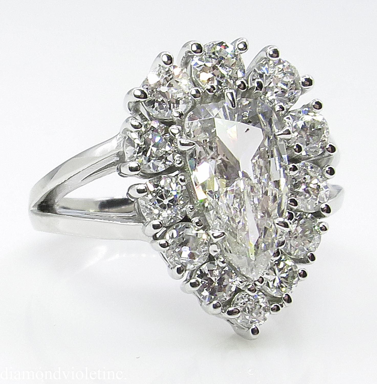This breathtakingly beautiful and Delicate Vintage Diamond Cluster Engagement Platinum Ring (stamped), the Center Diamond is 1.06ct Pear Center Diamond in I-J color and SI3 clarity (Near colorless and eye clear), EGL USA Certified.
It is surrounded