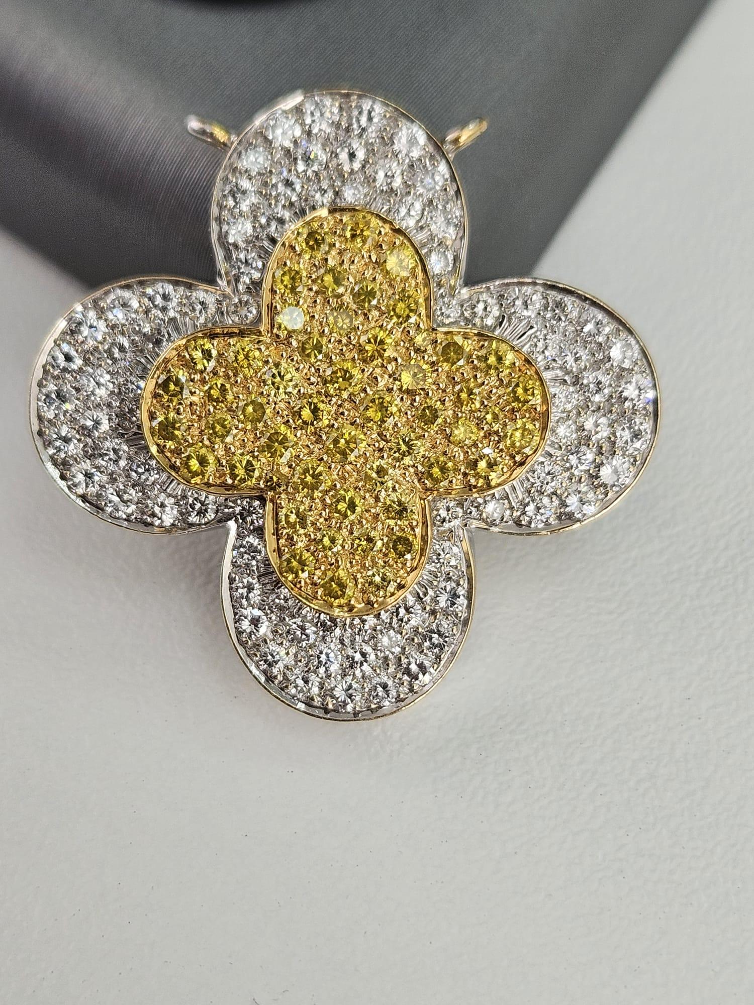 Introducing a stunning 2.14-carat Canary and White Diamond pendant, designed in a captivating clover shape that radiates both charm and sophistication. At the heart of this enchanting piece is a vibrant 0.99-carat Canary Diamond, captivating with