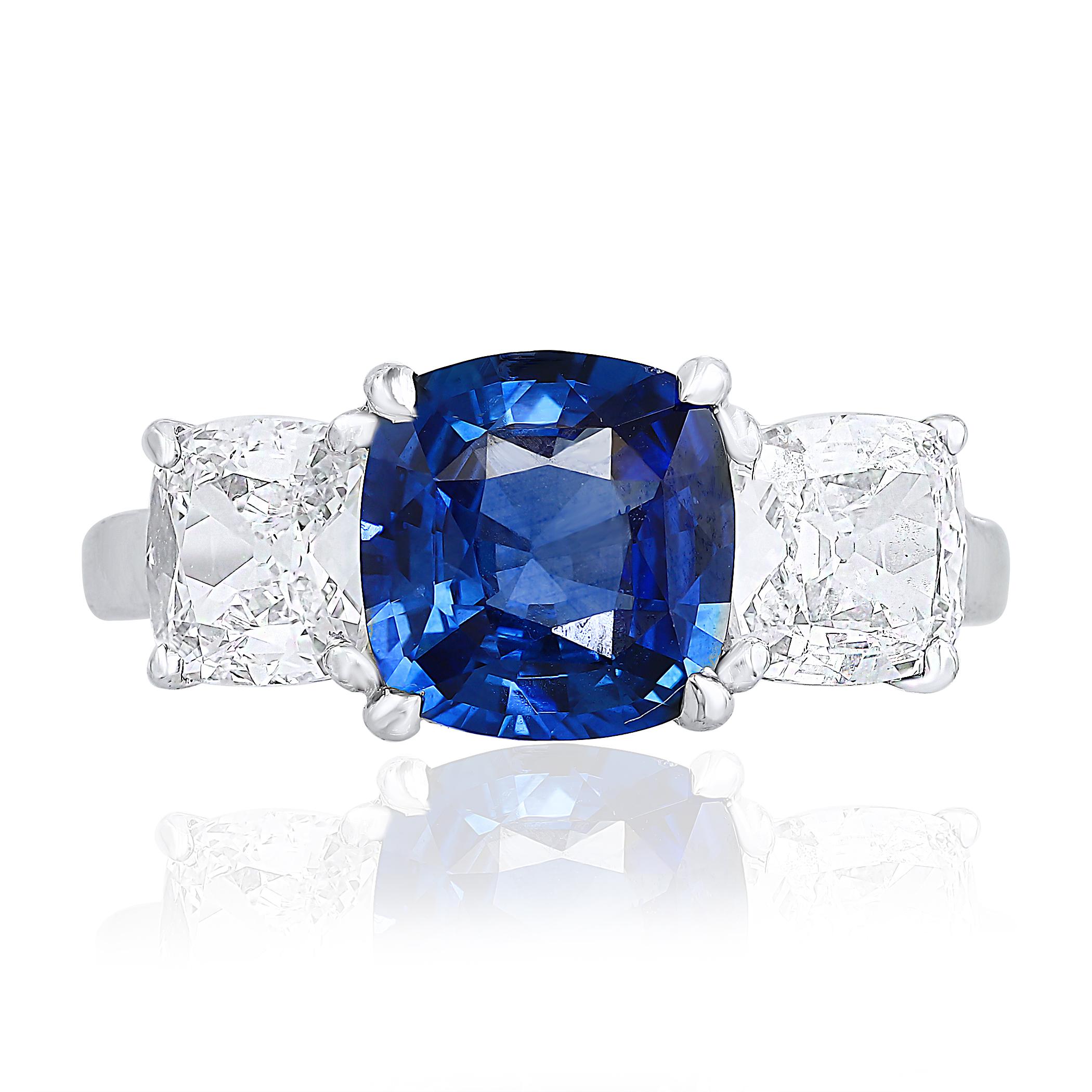 Showcasing a rare vibrant Cushion Cut Blue Sapphire weighing 2.14 carats and Flanking the center gemstone are two square brilliant diamonds weighing 1.40 carats total. Set in a polished platinum mounting.

Style available in different price ranges.