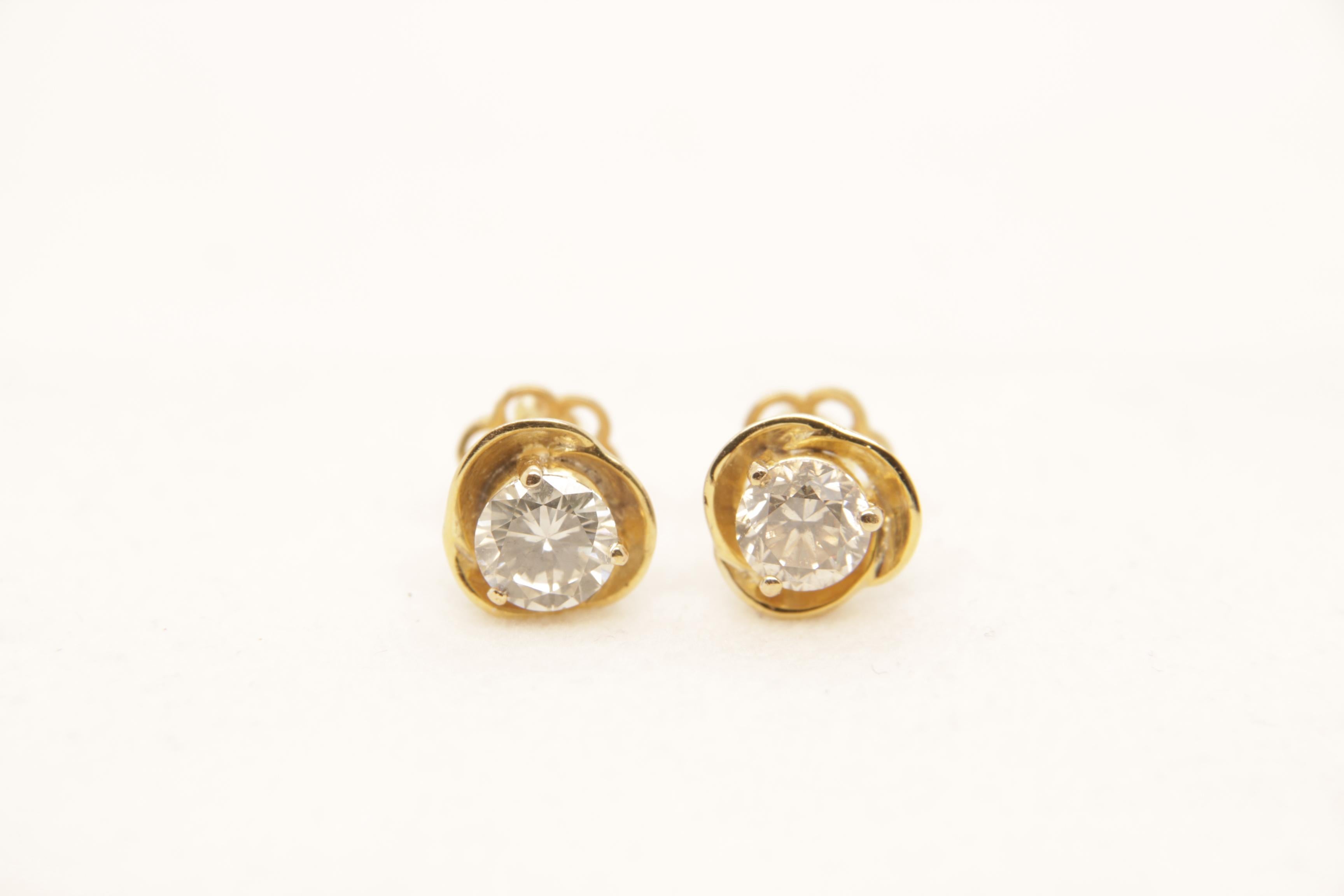 A brand new diamond earring in 18 karat gold. The two diamond weight is 2.14 carats and total earring weight is 3.57 grams.