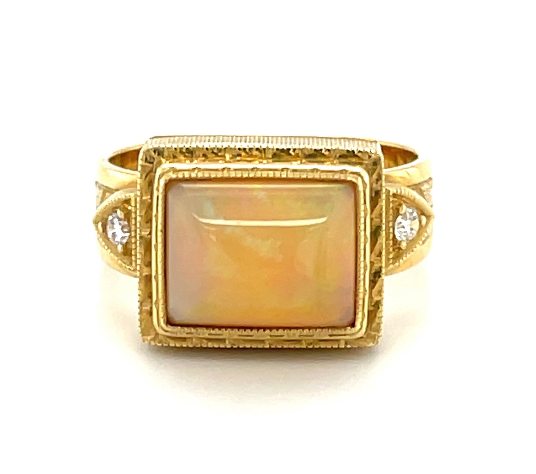 A bright and colorful 2.14 carat opal with an unusual rectangular cushion shape is featured in this handmade 18k yellow gold ring. The opal exhibits a variety of colors - predominately green, orange, yellow, and red, with subtle flashes of turquoise