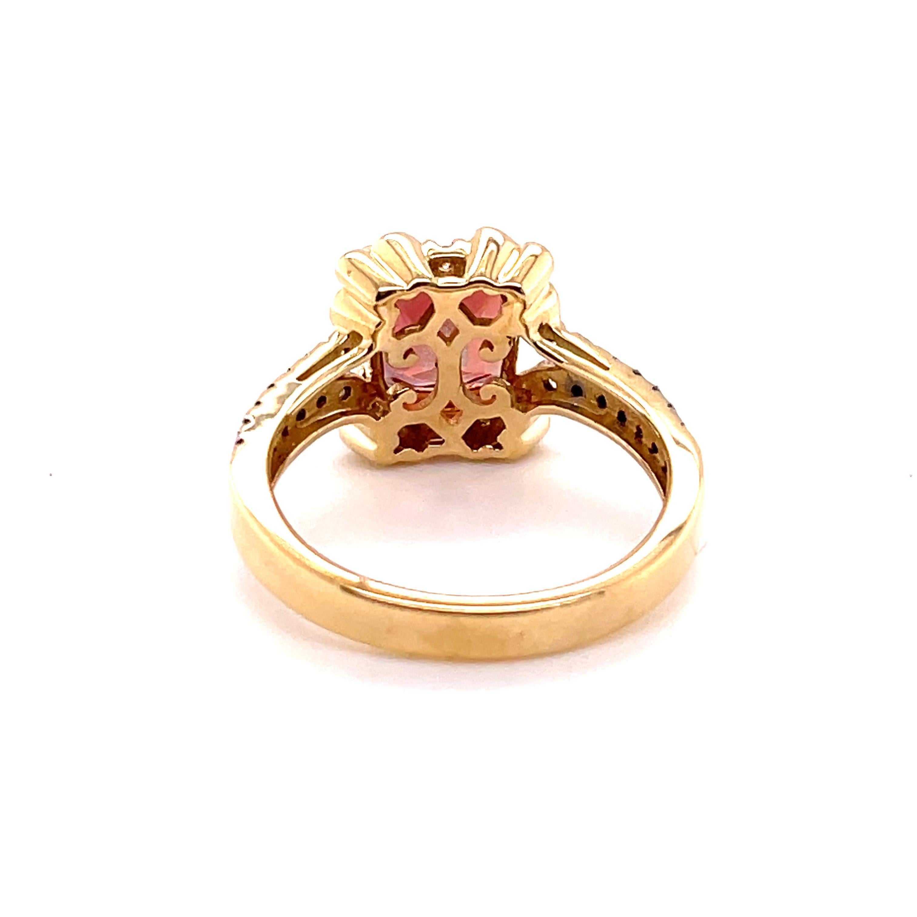 This rich orange square-cut Oregon Sunstone is set in polished 14k yellow gold, providing a classic look. The ring has four prongs and next to them on each corner of the basket is a leaf design, each containing three white Diamonds. The shank has a