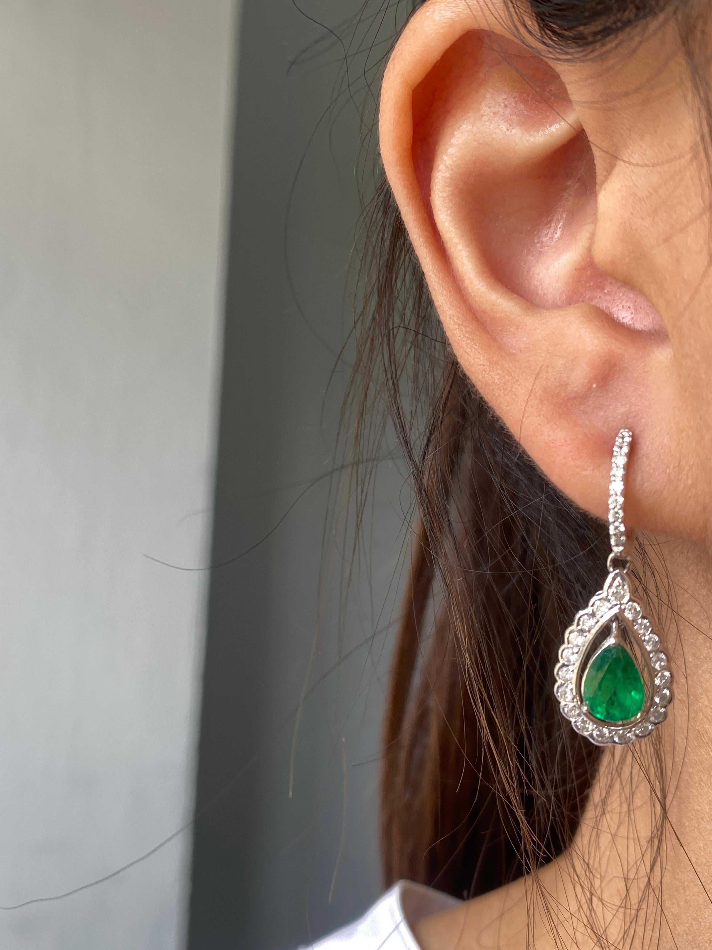 A pair of pear shape 2.14 carat Zambian Emeralds, adorned with 1.30 carat of White Diamonds, all set in 4.69 grams of solid 18K White Gold. The color of the Emeralds are ideal, vivid green, with great luster.
The earrings are around 2.5cm long.
We