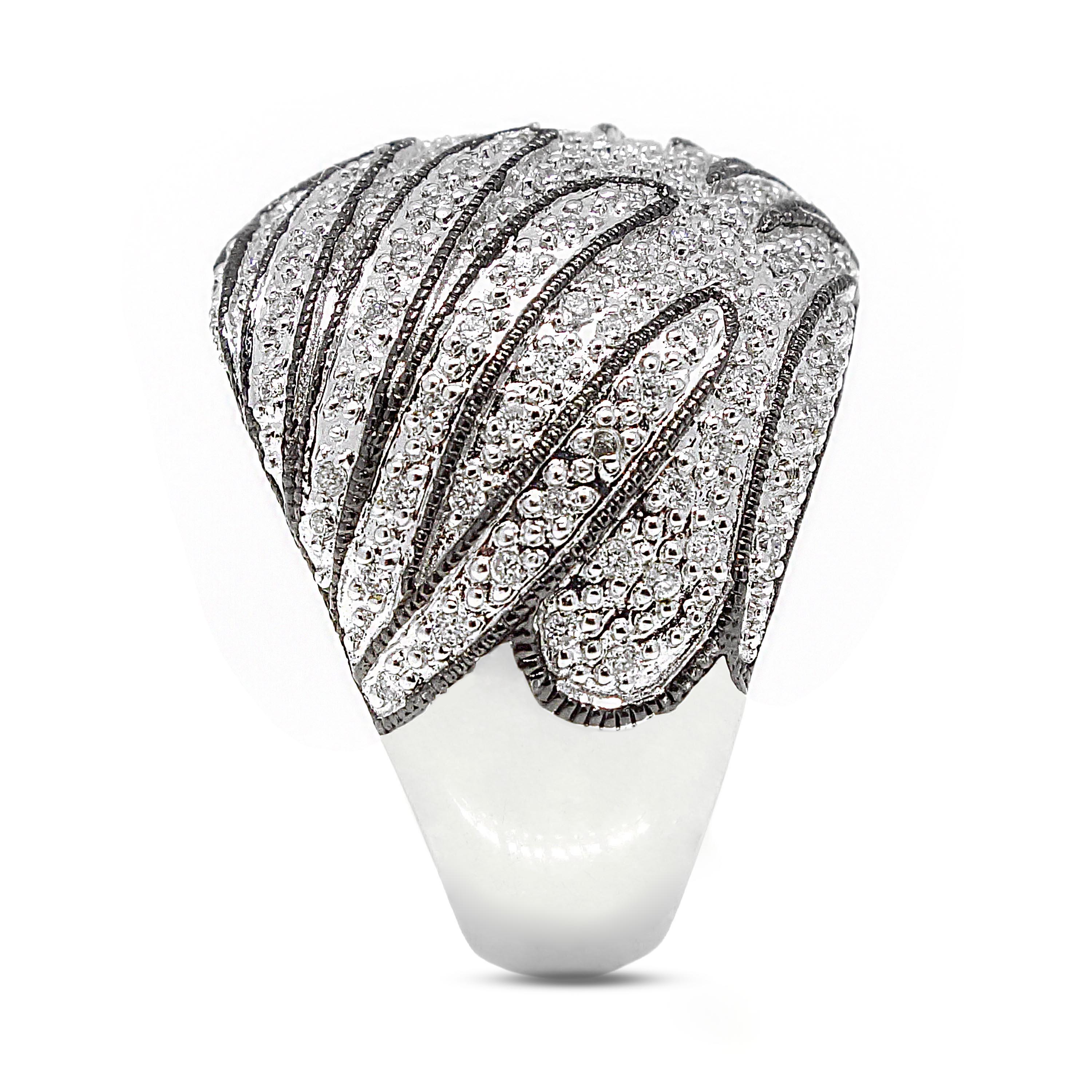 Diamond band containing 214 round brilliant cut diamonds of about 0.90 carats with a clarity of SI and color H. All diamonds are set in 14k white gold. The total weight of the band is approximately 15.35 grams.

Measurements: (W) 19.65 mm
Band Size: