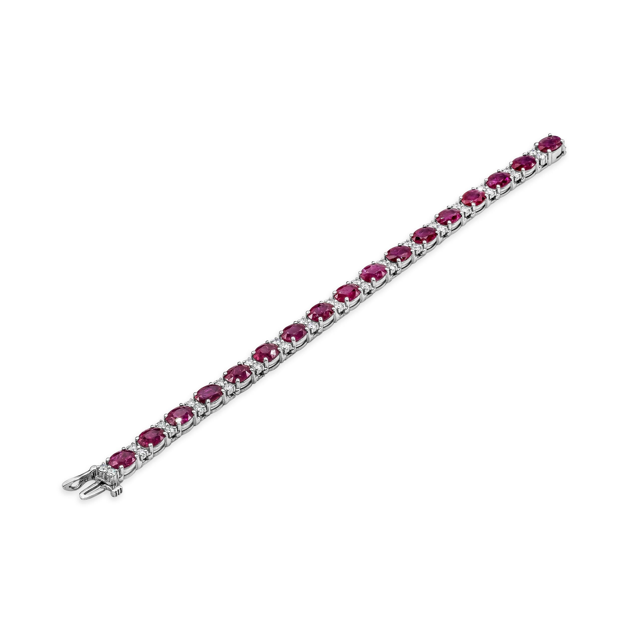 Showcasing beautiful oval cut rubies weighing 21.44 carats total, each spaced by round brilliant diamonds weighing 2.53 carats total. Made in 14k white gold. 

