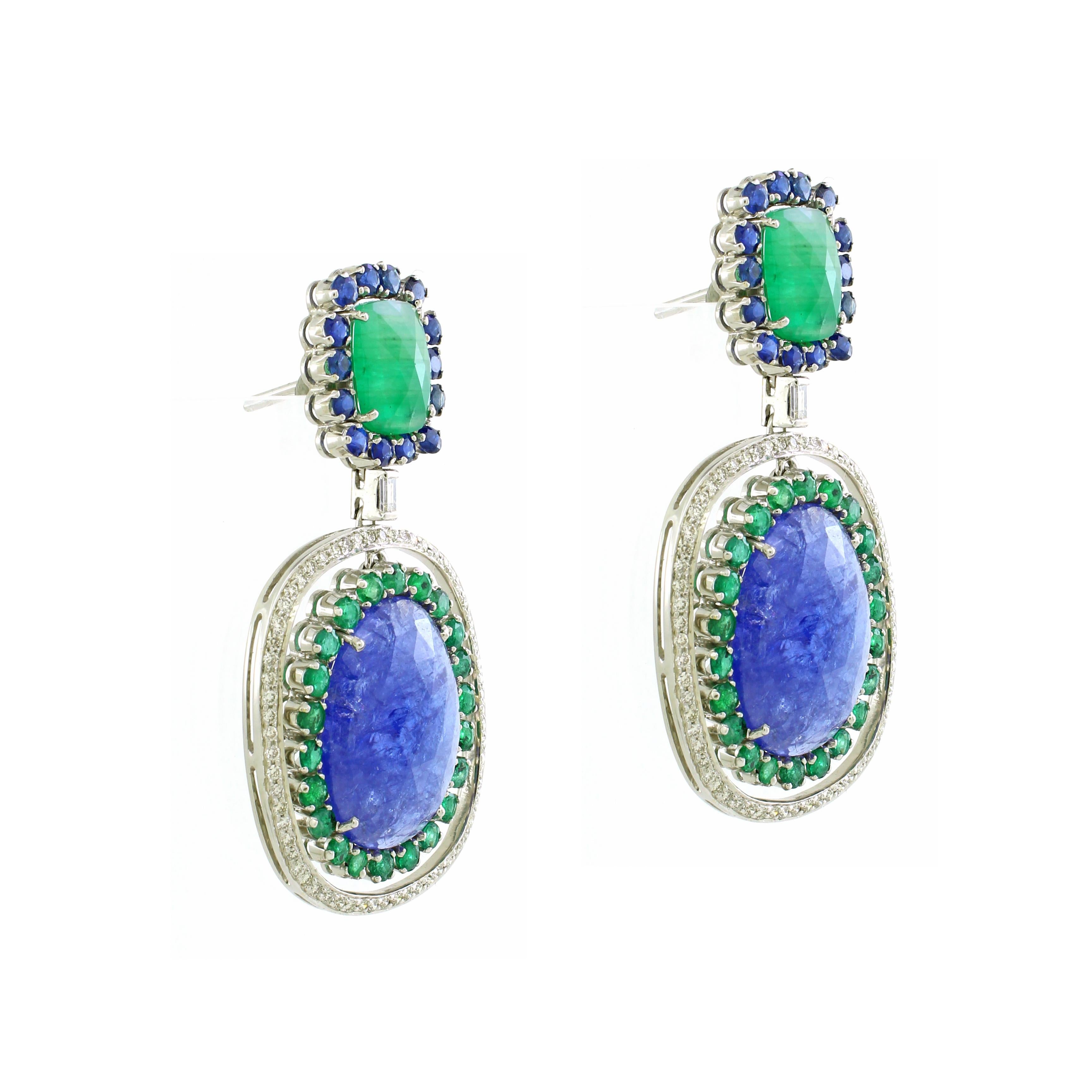 Introducing our enchanting Drop Earrings, a mesmerizing blend of elegance and allure. At the pinnacle of each earring rests a verdant green rose-cut gemstone, exuding natural radiance and charm, enveloped by a halo of brilliant blue round sapphires,