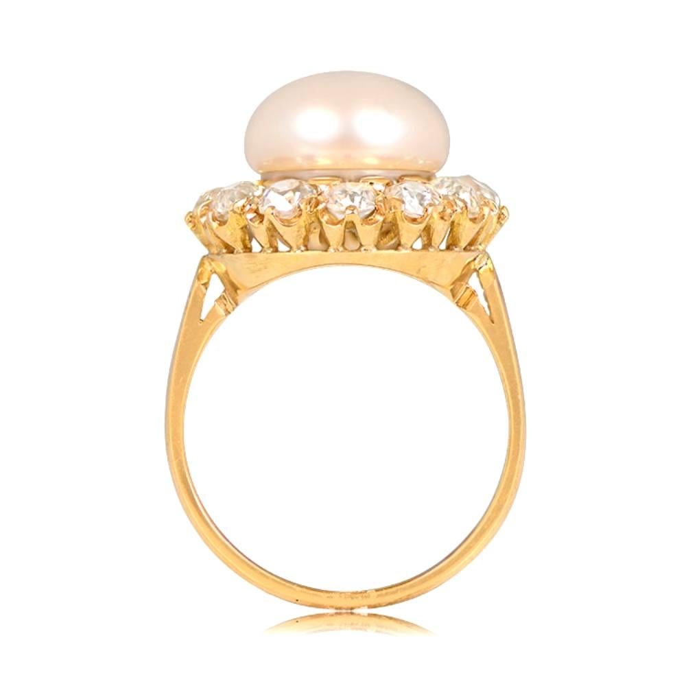 Experience the beauty of this stunning ring, boasting a lustrous natural saltwater button pearl weighing 21.48 chows, encircled by a captivating halo of old mine cut diamonds. The floral design of the diamonds adds a timeless charm, with a total