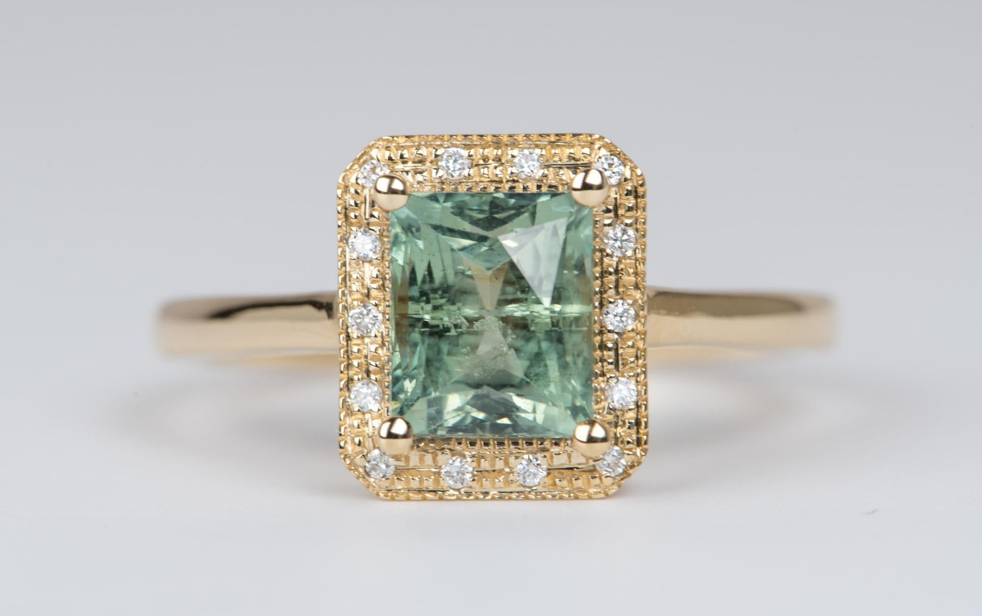 ♥  A solid 14k yellow gold ring set with a large rectangle-shaped Montana sapphire in the center, flanked by a textured diamond halo and delicate milgrain details
♥  The Montana sapphire has the typical silk found in Montana sapphires. 
♥  The