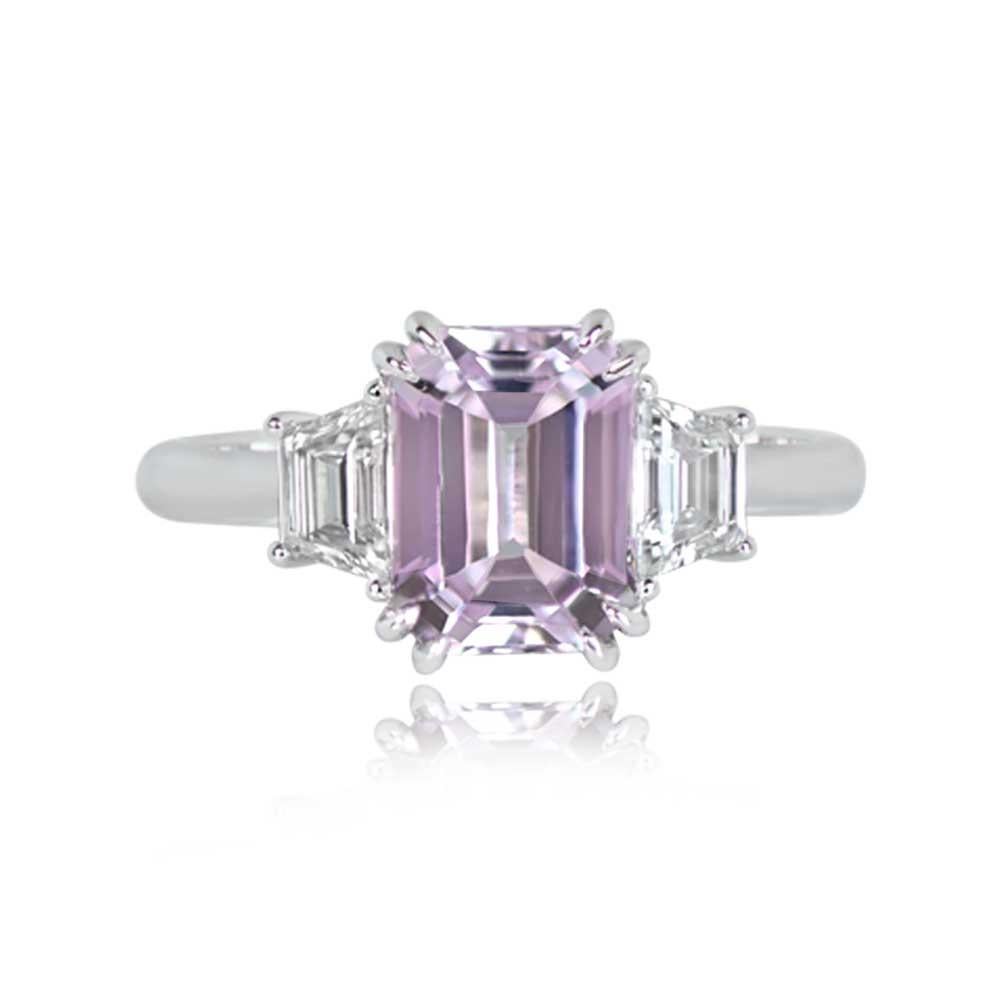 An exquisite gemstone ring showcases a vibrant emerald-cut natural kunzite, weighing around 2.14 carats, and radiating a lovely pink hue. Set in prongs, it is complemented by trapezoid-cut diamonds on both shoulders. Crafted in platinum, this ring