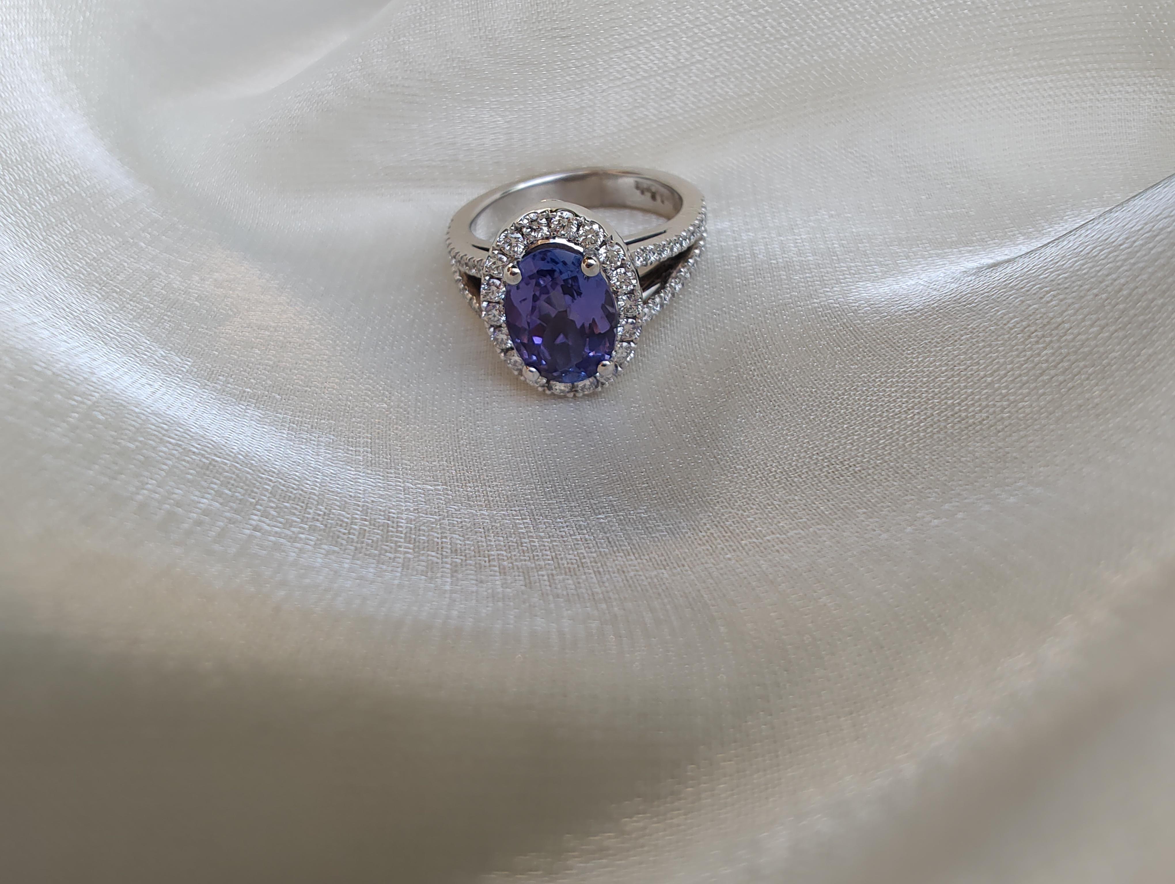 Handcrafted in 18ct white gold natural, luxurious, oval bluish-purple Tanzanite AAA Grade at 2.14cts and diamond halo cocktail ring.
Every Euphoria Jewels item is one of a kind and will arrive with a Certificate of Authenticity

D58 = .78ct E/VS1
