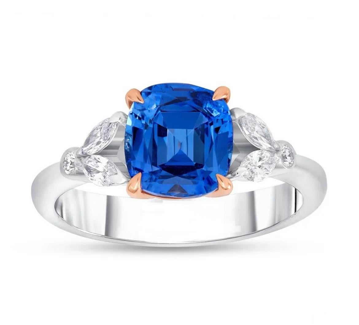 18K white with rose gold ring, featuring a delightful 2.14-carat, untreated Blue Sapphire from Sri Lanka. Complemented by marquise and round white diamonds totaling 0.25 cts, this remarkable sapphire is accompanied by an AGL brief report.