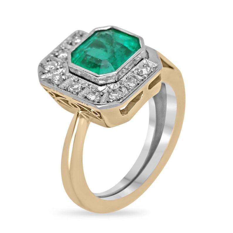 Experience timeless elegance with our exquisite emerald and diamond ring, featuring a stunning 1.98-carat Asscher cut Colombian emerald. The medium rich green color of the emerald is beautifully showcased in a bezel setting, ensuring its brilliance