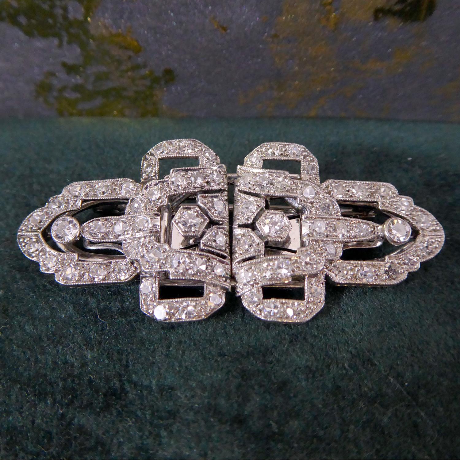 A splendid Art Deco diamond brooch being a double clip which detaches from its back plate so that it can also be worn as a dress clip pinned to either side of the neckline.  I have also worn this as sleeve clips pinned to the cuff of a velvet
