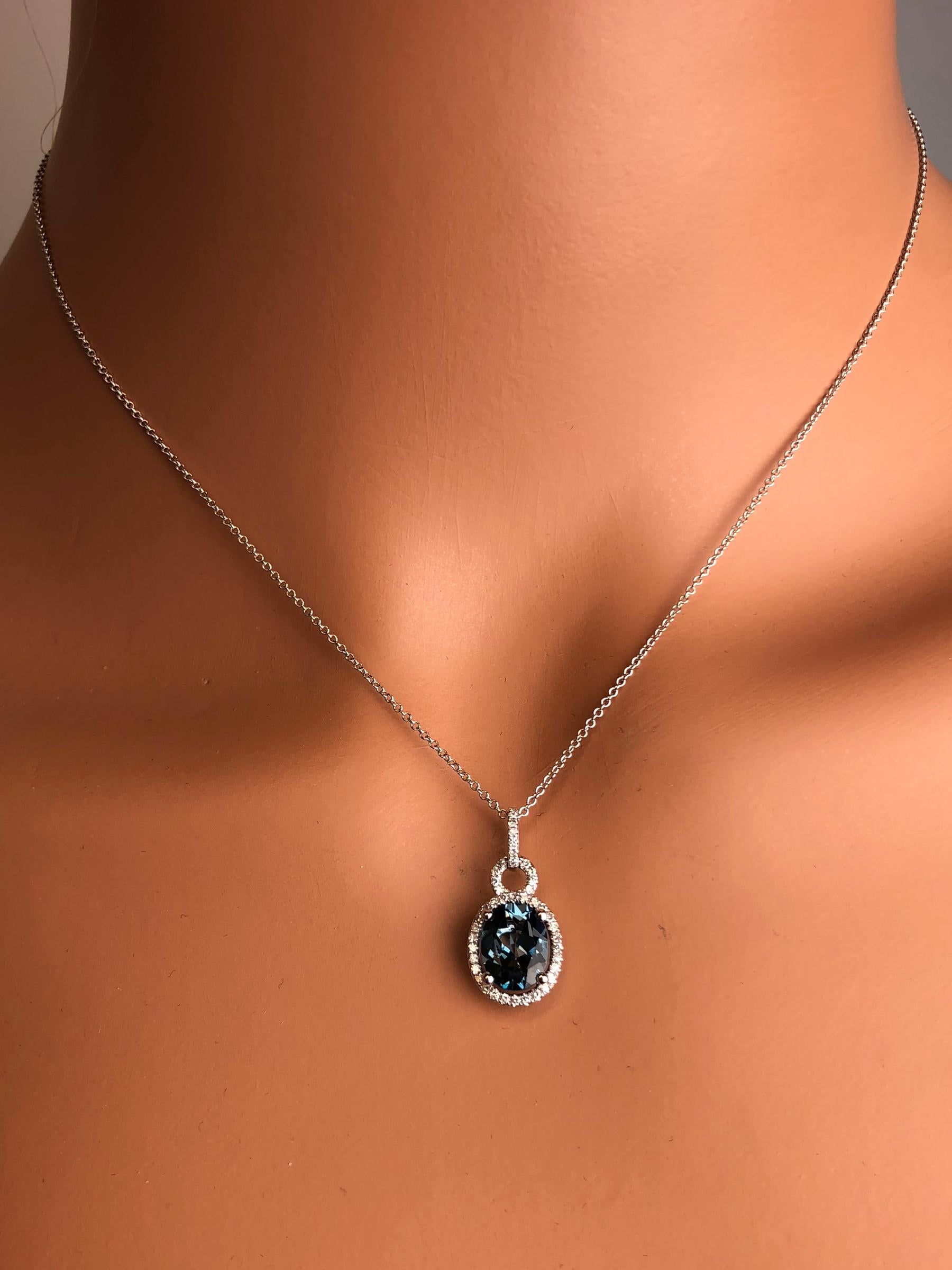 (DiamondTown) This lovely halo pendant features 2.15 carats oval cut Blue Topaz surrounded by a halo of round white diamonds.

Center: 2.15 carats Blue Topaz
Diamond Halo: 43 round diamonds total 0.16 carats
Set in 14k White Gold.

Many of our items