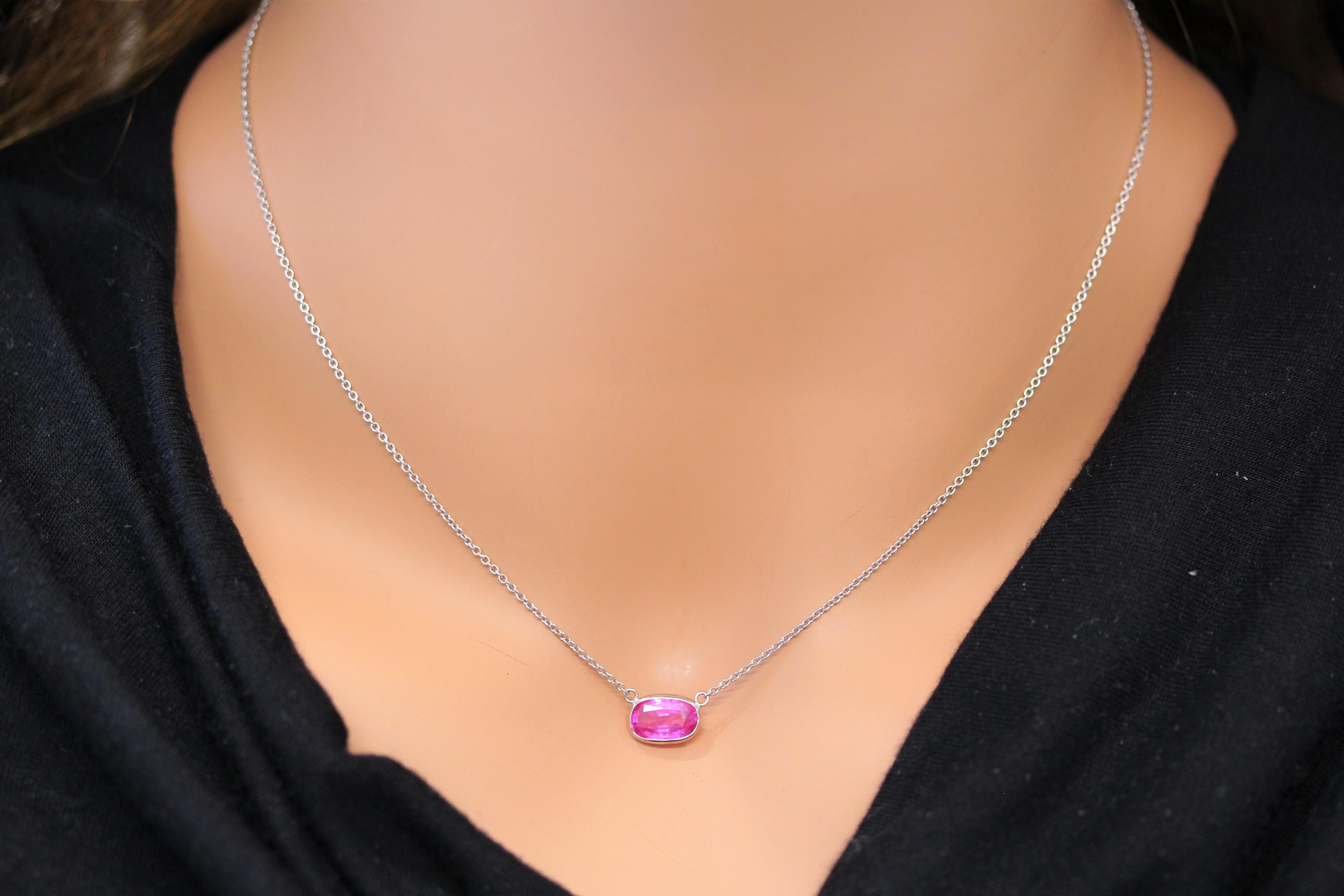The necklace you're describing features a 2.15-carat cushion-cut pink sapphire set in a 14 karat white gold pendant or setting. Pink sapphires are known for their lovely color and durability, making them a great choice for jewelry. The cushion cut