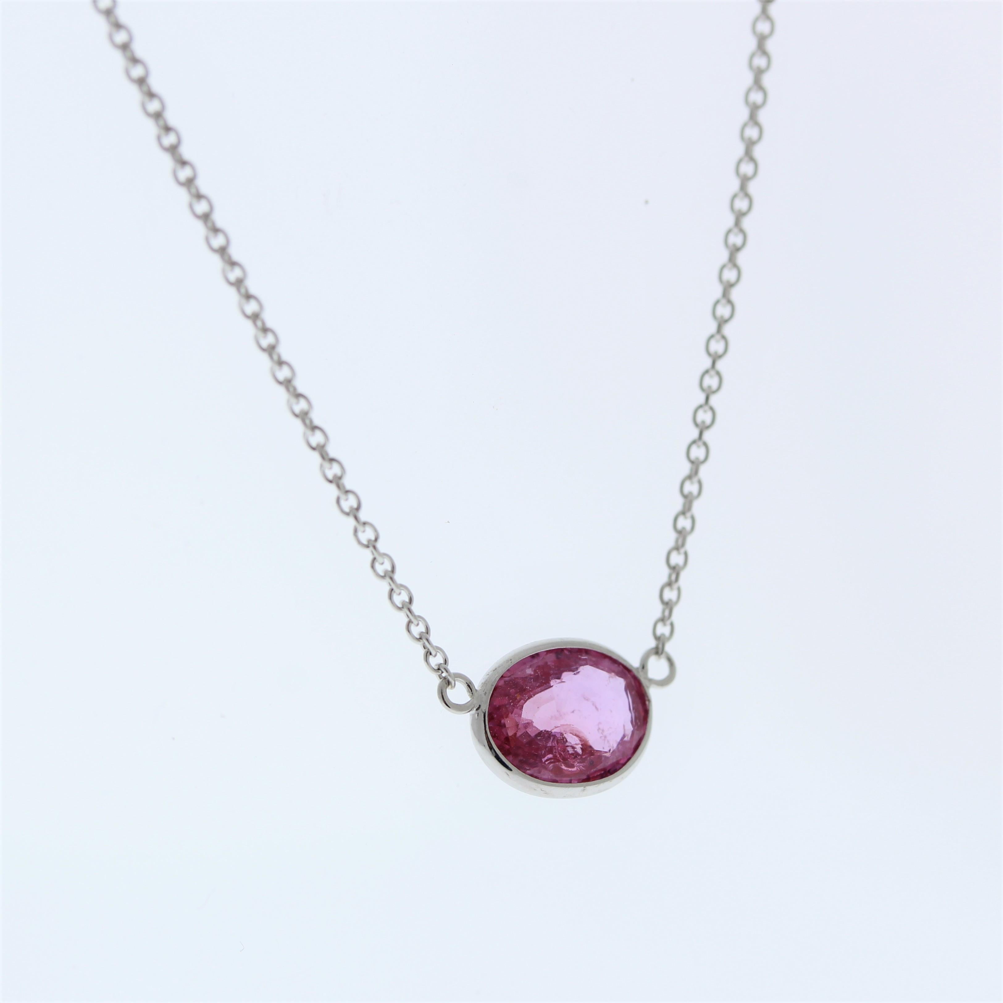 This necklace features a 2.15-carat oval-shaped Padparadscha gemstone with pink hues, set in a 14 karat white gold pendant or setting. The combination of the rare Padparadscha gemstone and the white gold setting suggests a sophisticated and