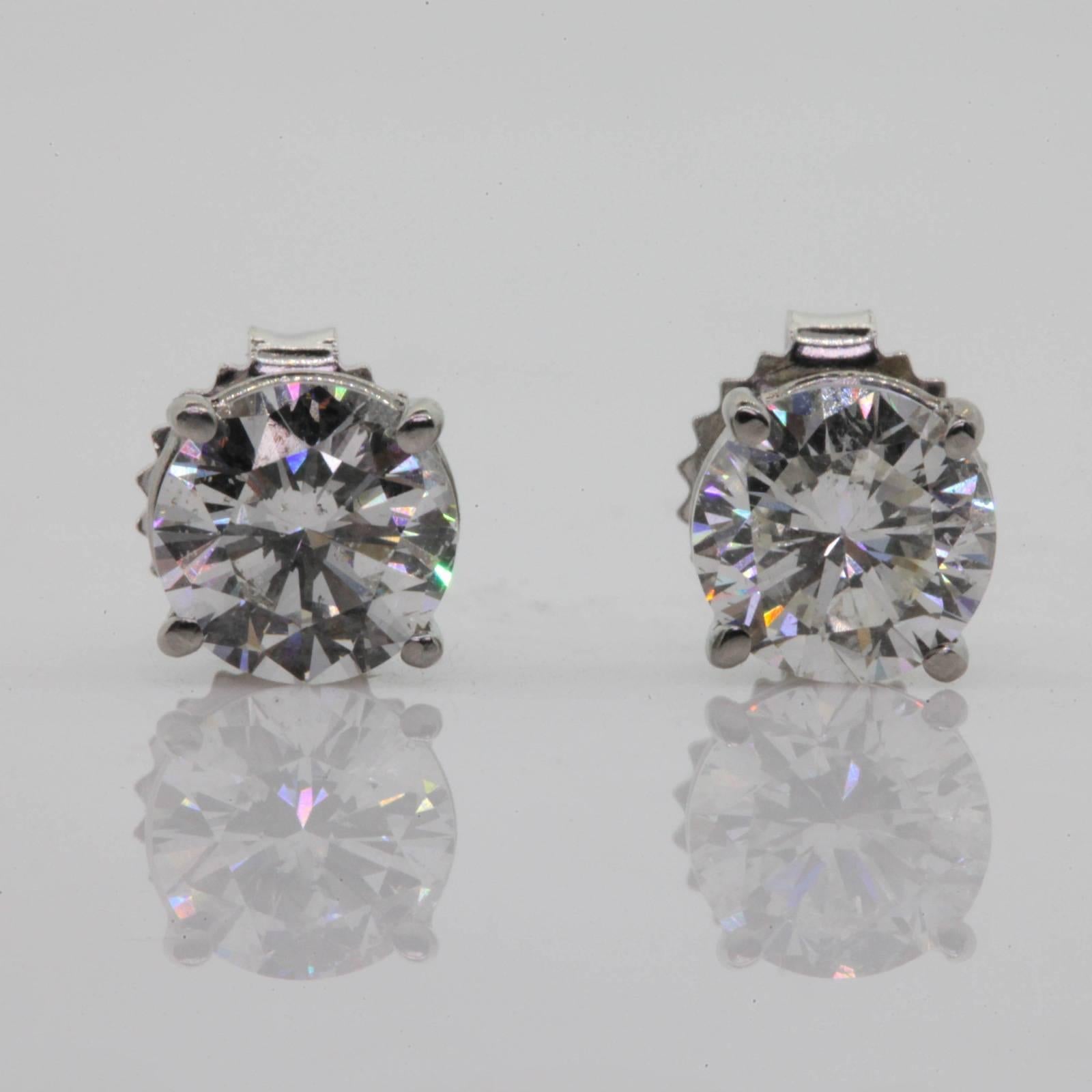 You can't go wrong with a pair of one carat each Diamond studs!  This pair features one Round Brilliant Diamond weighing 1.12 carat J color - SI3, and the second Round Brilliant weighs 1.03 carat H color - SI3.  Diamonds are set low in 14KT white