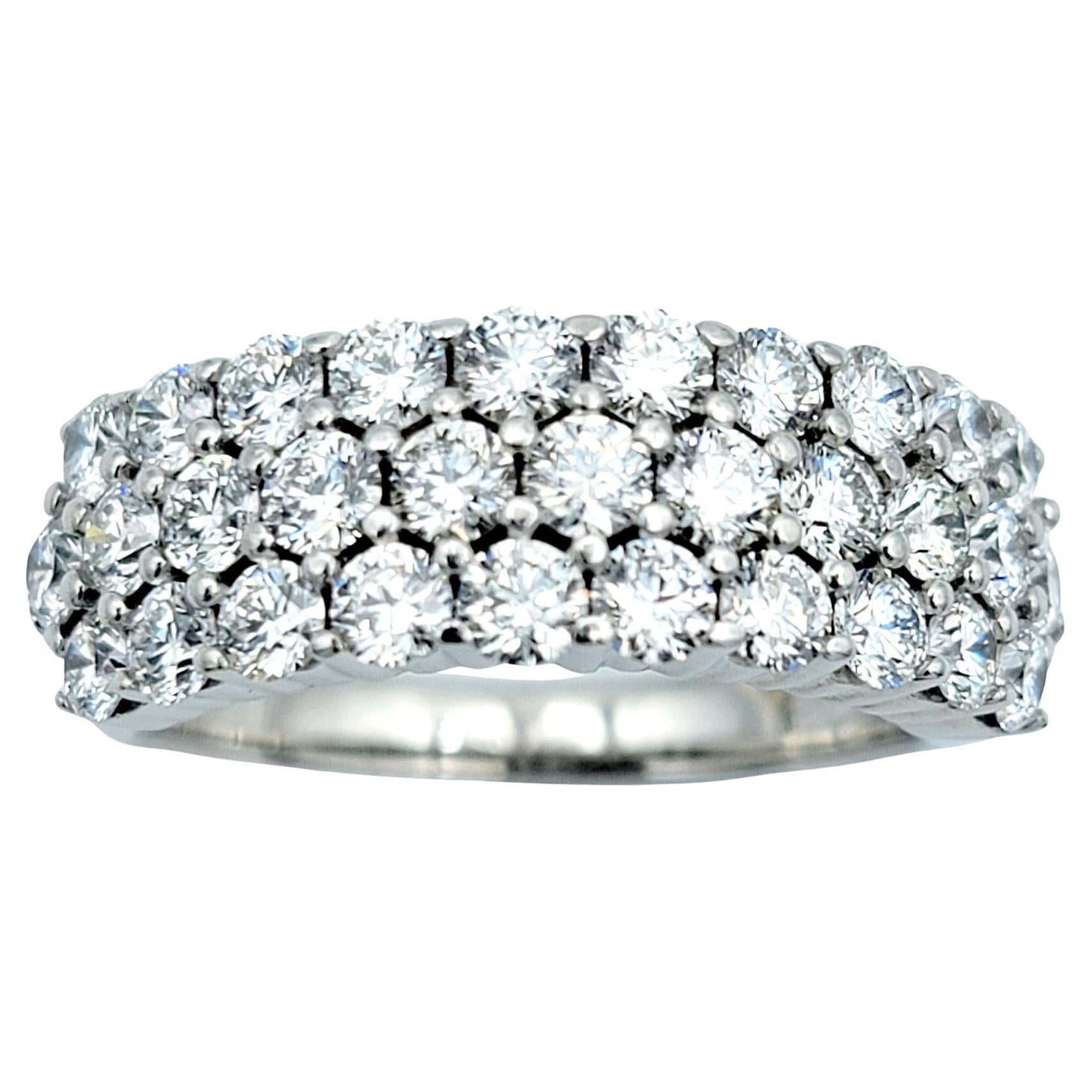 Ring size: 6.75

Elegance meets sophistication in this stunning three-row diamond band ring, meticulously crafted in lustrous 18 karat white gold. Designed to captivate and endure, this exquisite piece exudes timeless charm and luxurious