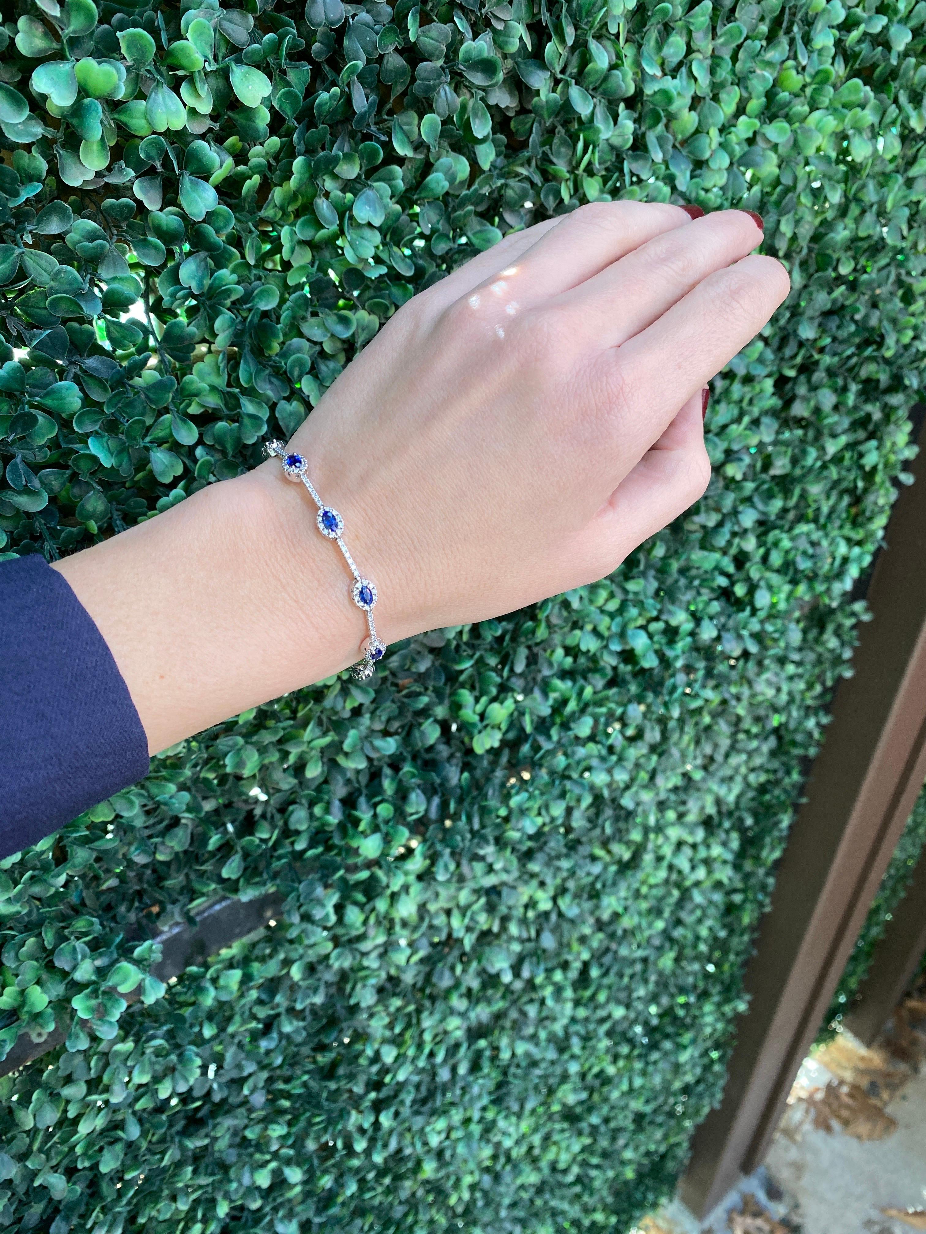 This bracelet features 2.15 carats of natural oval cut blue sapphires accented by 2.15 carat total weight in round diamonds set in 14 karat white gold. 
Measurements: Length is 7