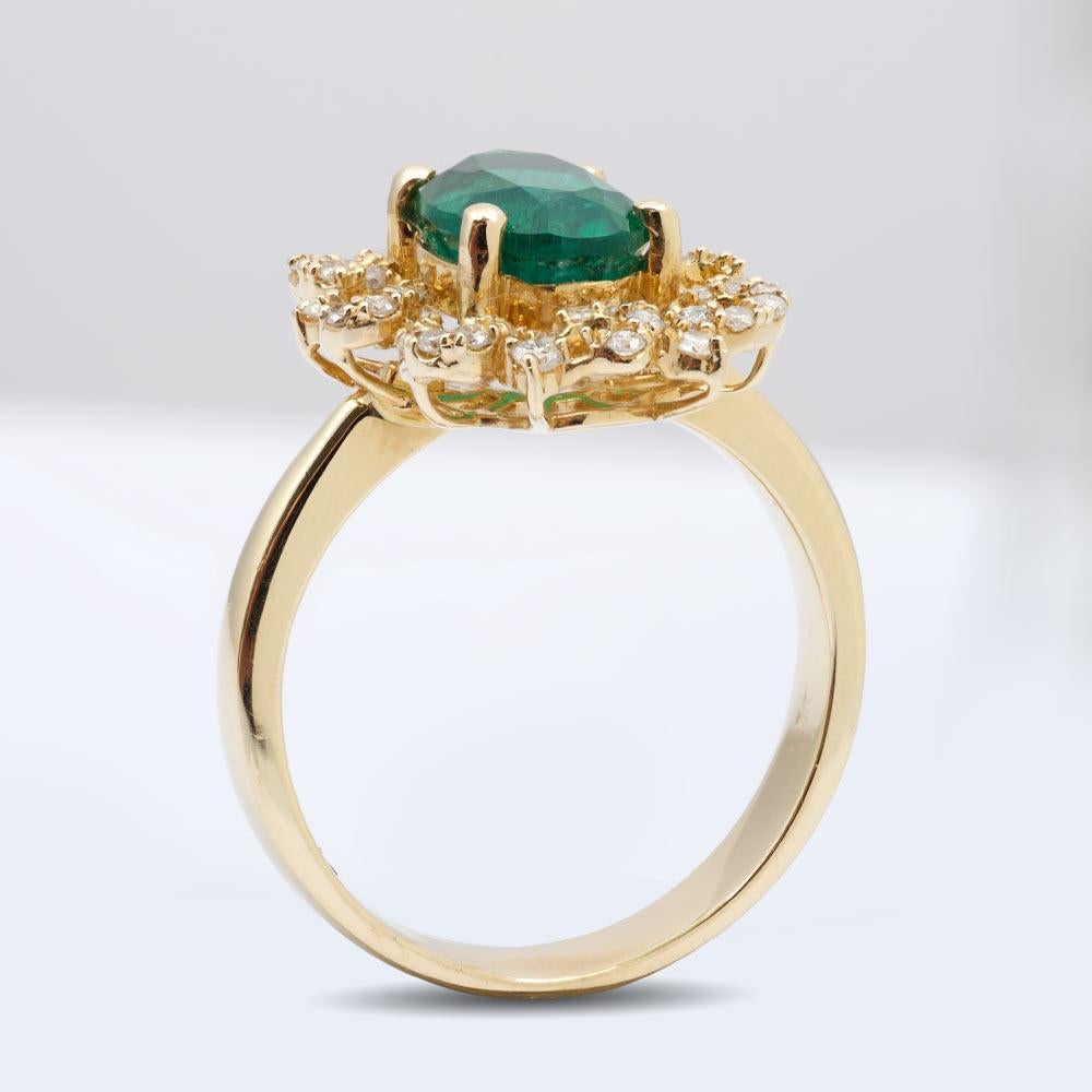Crafted in 14K yellow gold, this unique ring has a 2.15 carat lush green Emerald at its center. Mounted upon an intricately cut floral bed of diamonds, the emerald takes on a different aura. The ring’s feminine design is what adds charm and