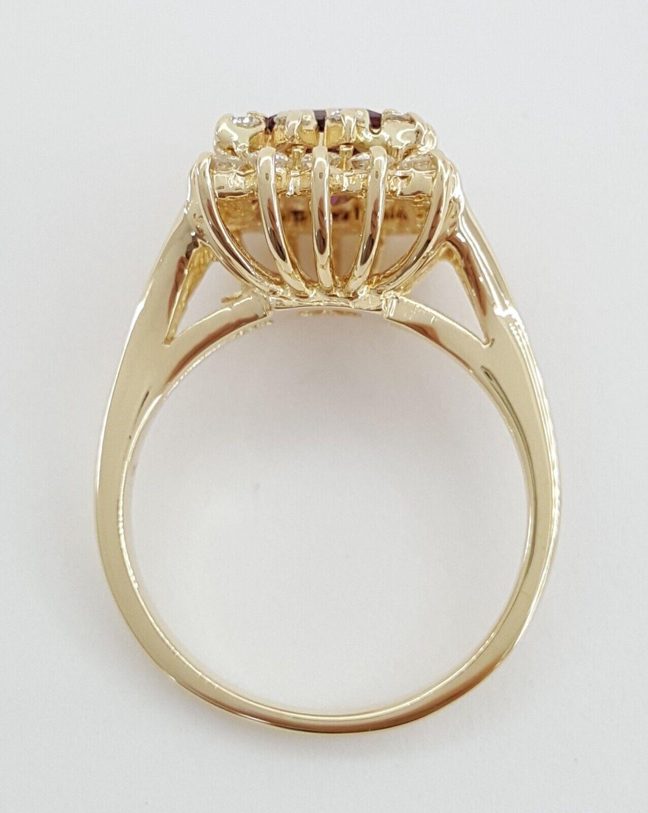 2.15 ct Total Weight Baguette Cut Garnet & Round Brilliant Cut Diamond Double Halo Crossover 14k Yellow Gold Engagement Ring.
The ring weighs 5.6 grams, size 6.75, the center stone is a Baguette / Emerald Cut Pink Tourmaline weighing approximately