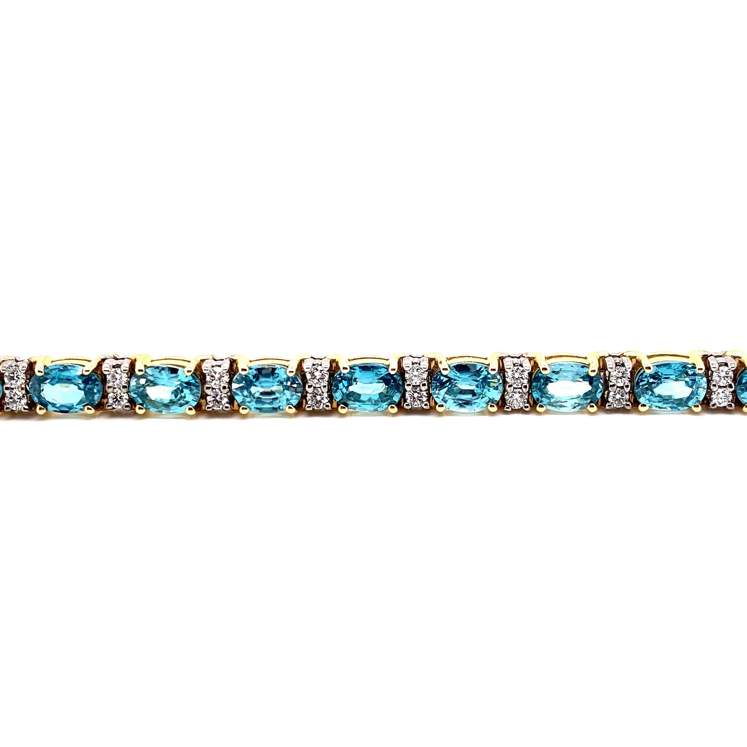 This stunning Blue Zircon and Diamond Bracelet features 18 Beautiful Oval Blue Zircons, each separated by set of 2 Radiant Round White Diamonds. This Bracelet is set in 14K Yellow and White Gold, Yellow Gold Baskets for the Blue Zircons and White