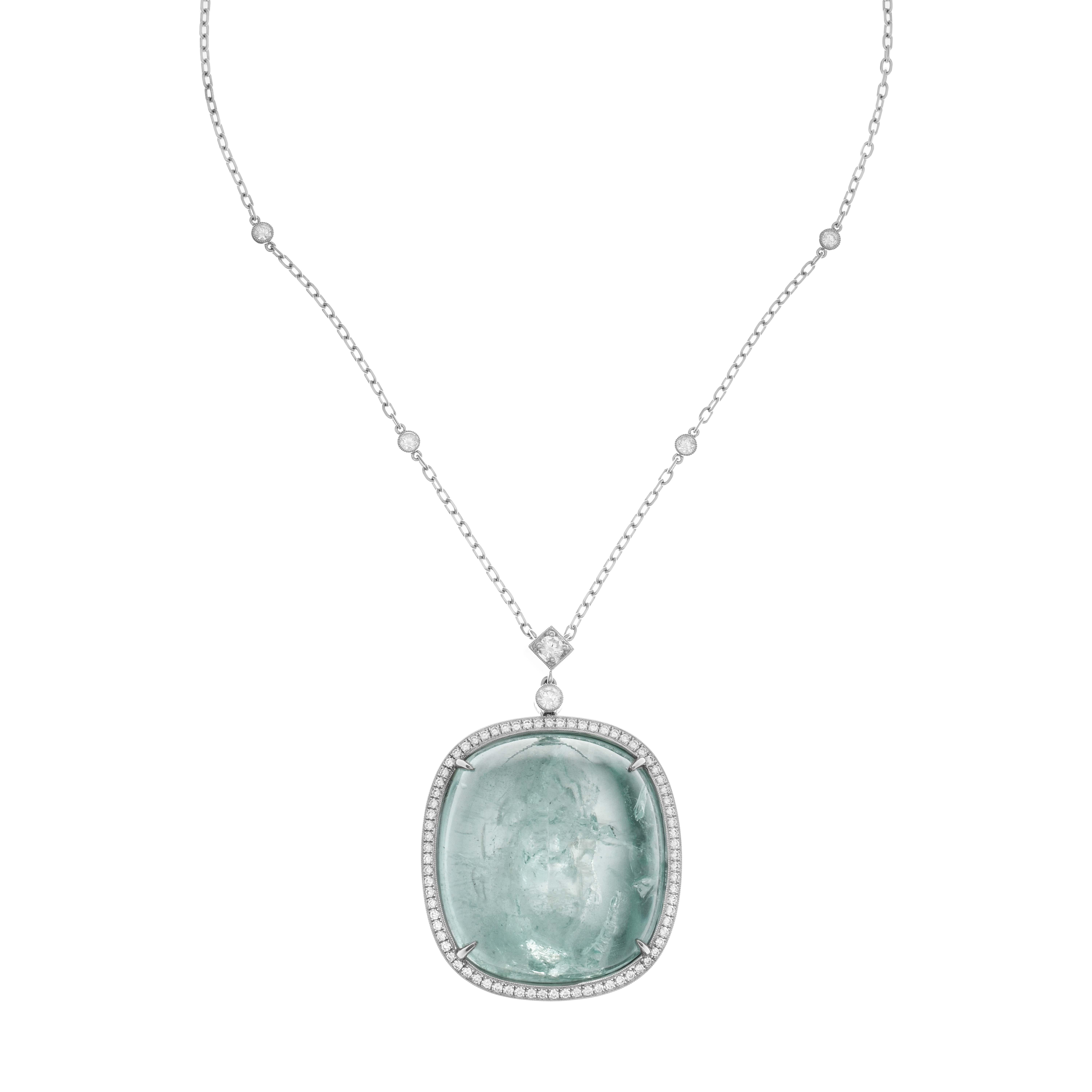 This elegant pendant necklace showcases a large aquamarine gemstone, complemented by a border of white diamonds. The pendant is suspended from a white gold chain which is embellished with four white diamonds. For an added touch of beauty, there are