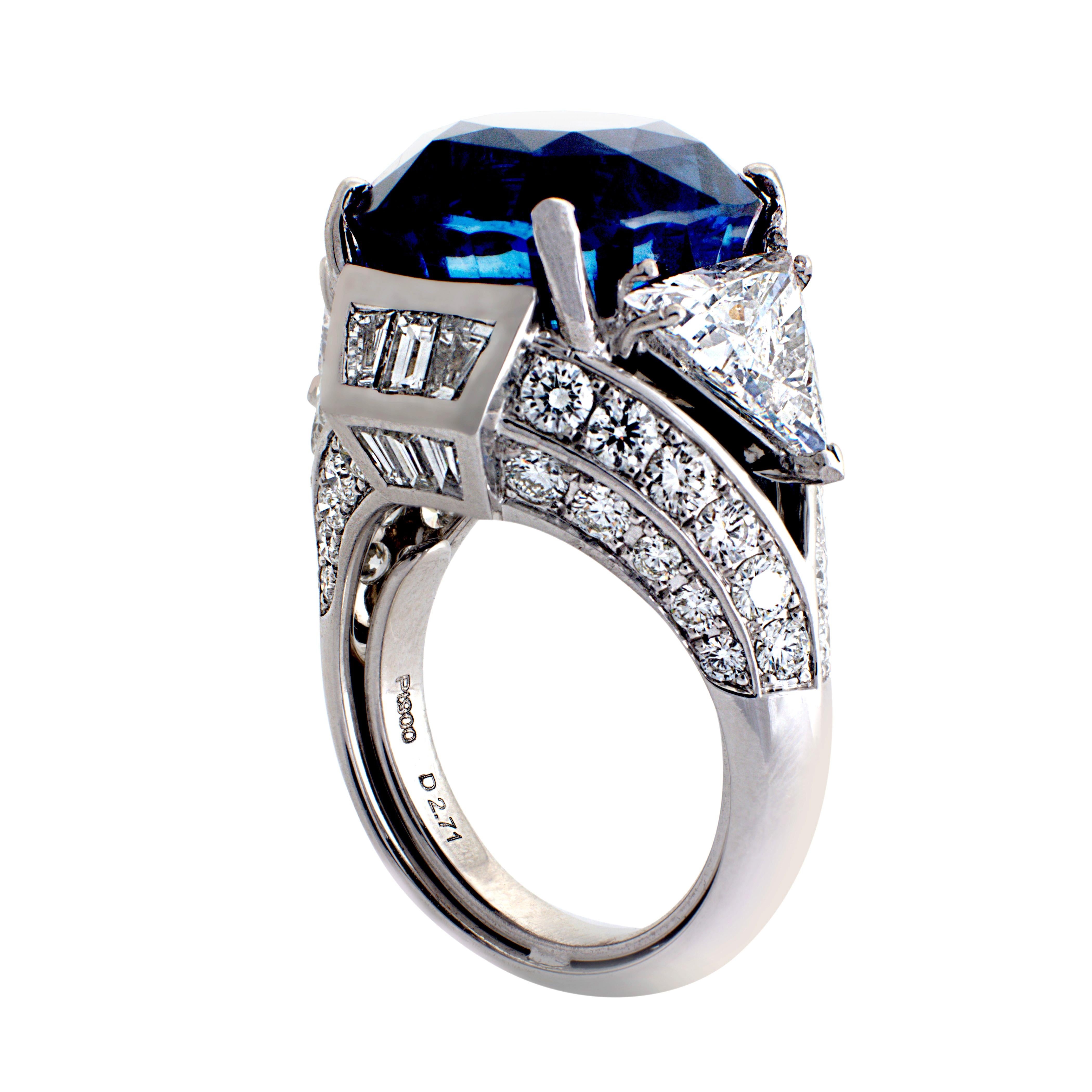 A truly stunning platinum ring, set with a brilliant 21.53 carat GIA Certified, non-heated, vivid blue, cushion-cut Sri Lankan sapphire center stone. The sides are flanked with 2 trillion-cut (Idar-Oberstein Certified) diamonds 1.50 carats and 1.58