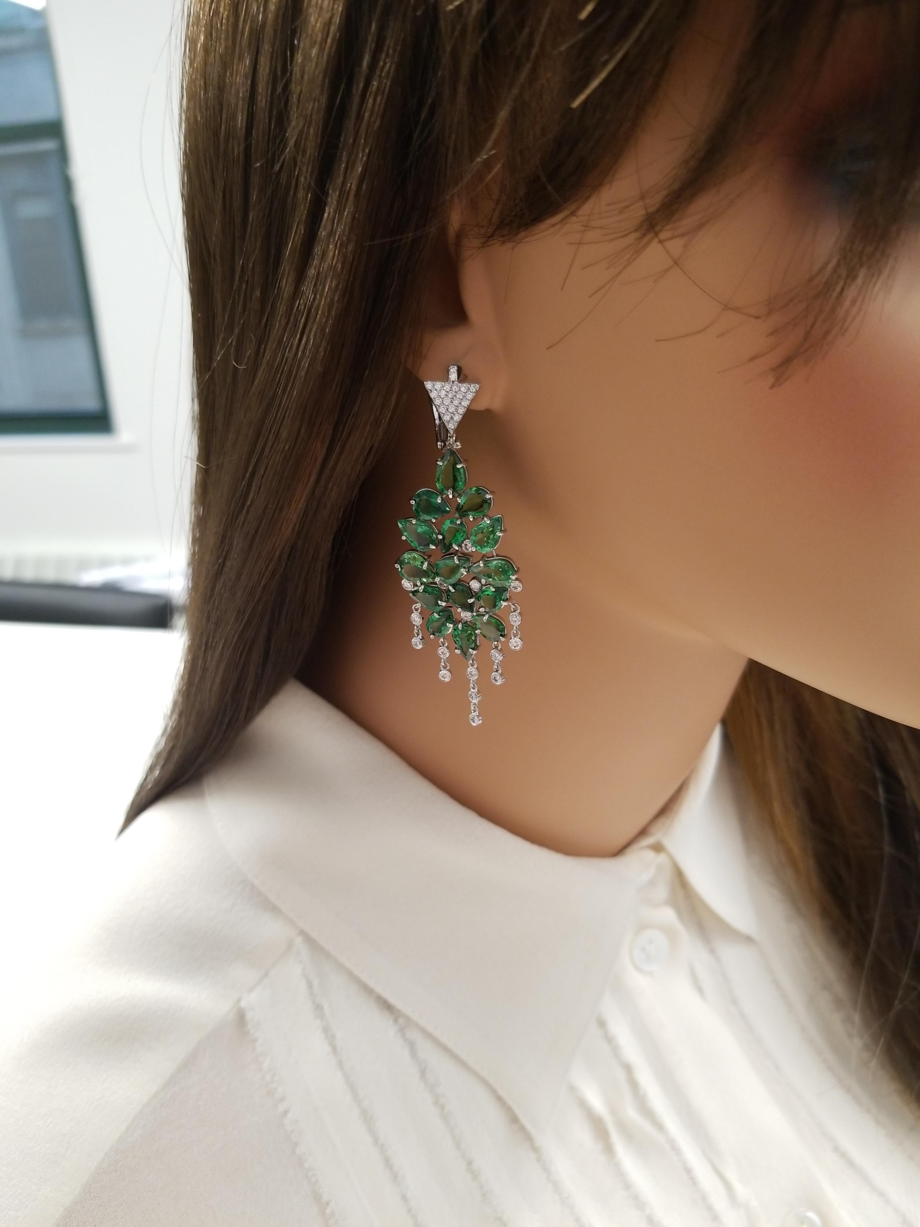 30 pear-shaped vibrant tsavorite garnets adorn these incredible chandelier earrings totaling 21.53 carats in prong settings.  The tsavorite garnets are sourced from Tanzania. The color is intense green; its luster and transparency is excellent. 80