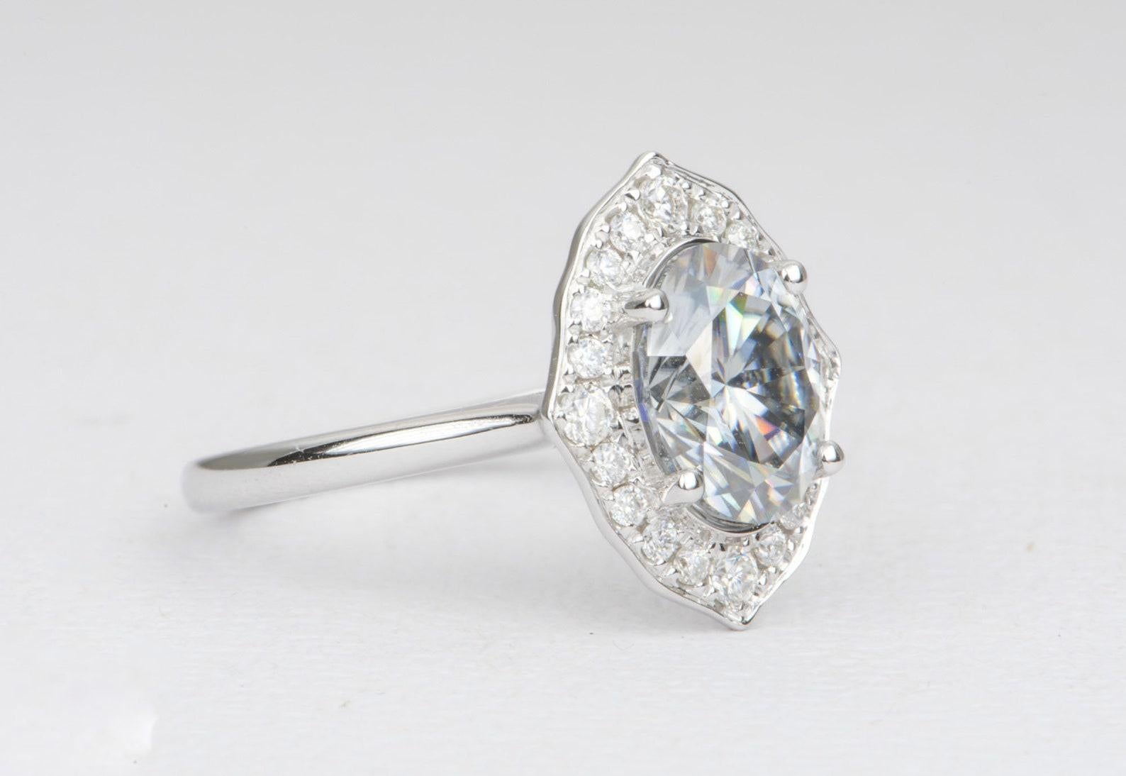 â™¥ This ring features a 2.15ct oval-shaped gray moissanite in the center, with a beautiful sparkly white moissanite halo in a feminine floral style
â™¥ Solid 14K white gold
â™¥ The center moissanite is of a really beautiful silver gray color and