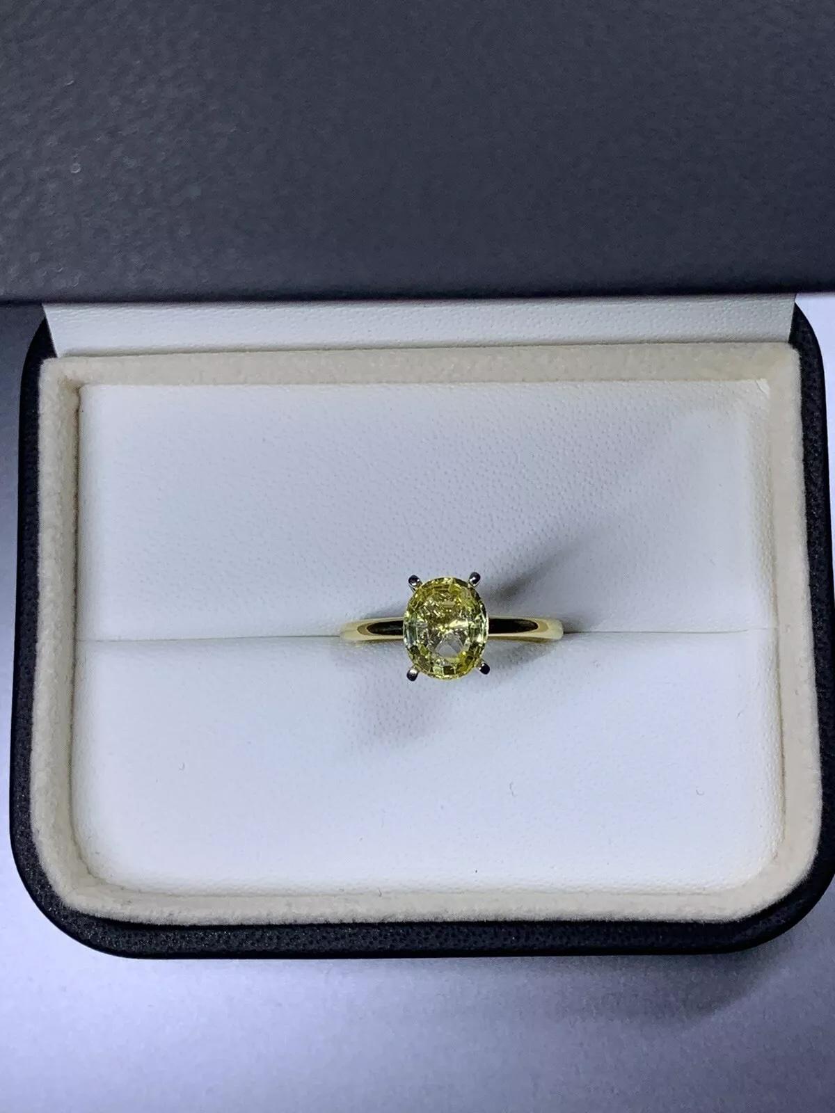 2.15ct Yellow sapphire engagement ring in 18ct yellow gold.

Beautiful yellow vivid sapphire oval cut gemstone natural untreated engagement ring total weight of the gemstone 2.15ct.

Chunky large yellow sapphire gemstone solitaire engagement ring in