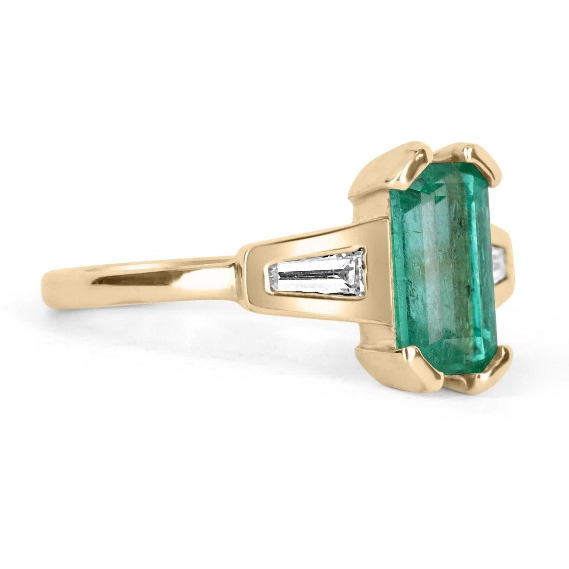 Featured is a stunning Colombian emerald and diamond, three-stone ring. A full 1.90-carats of pure, natural, Colombian beauty! This emerald displays a gorgeous, spring green color, with excellent eye clarity. On either side of this beauty, are