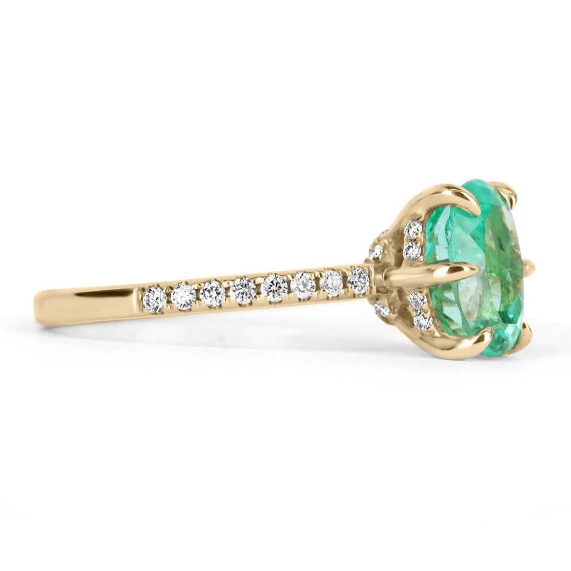 Elegantly displayed is a oval-cut Colombian emerald and diamond accent ring. The center gem is a fine quality, oval cut, emerald filled with life and brilliance! Among the emeralds, impressive qualities are its vibrant color and beautiful eye