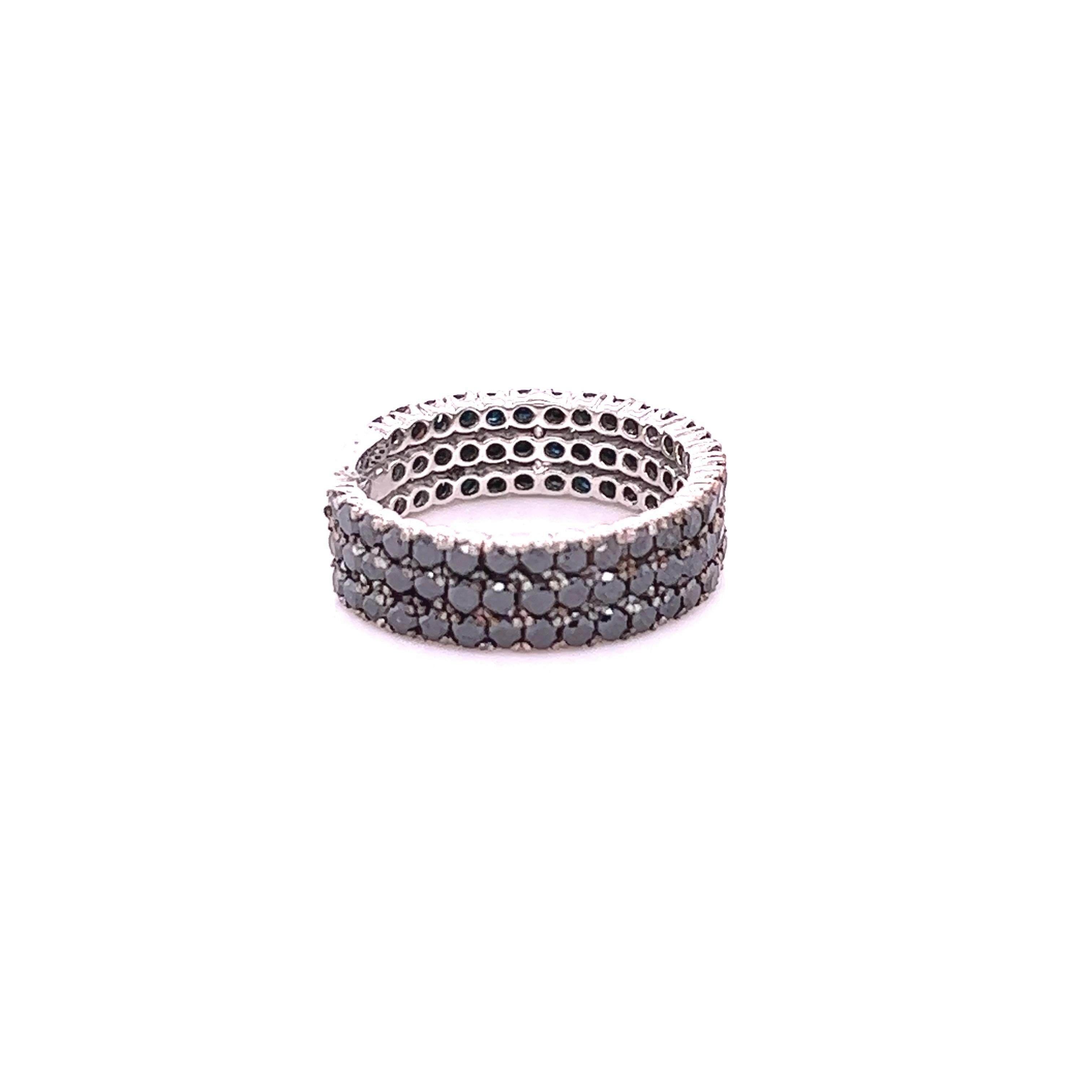 This ring has 98 Natural Round Cut Black Diamonds that weigh 2.16 carats. 
The black diamonds are natural and are color treated to attain its black color. 

It is set in 14 Karat White Gold and has a weight of approximately 4.0 grams. 
The width of