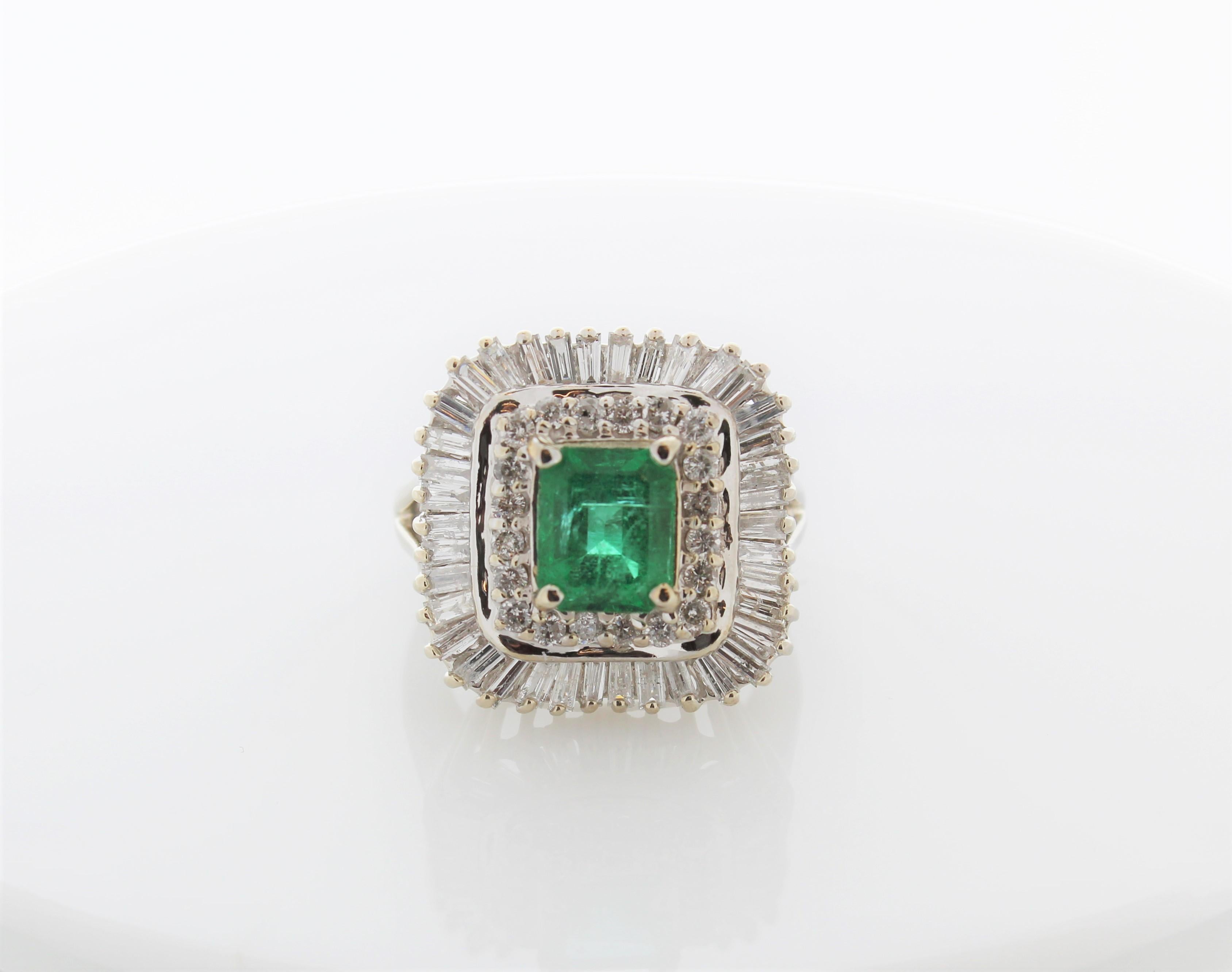 This unique halo cocktail ring features a cushion cut  emerald weighing 2.16 carat. A total of 59 mixed cut diamonds frame this center stone emerald in a dazzling halo cluster totaling 4.50 carats. Created in brightly polished 14 K white gold.
