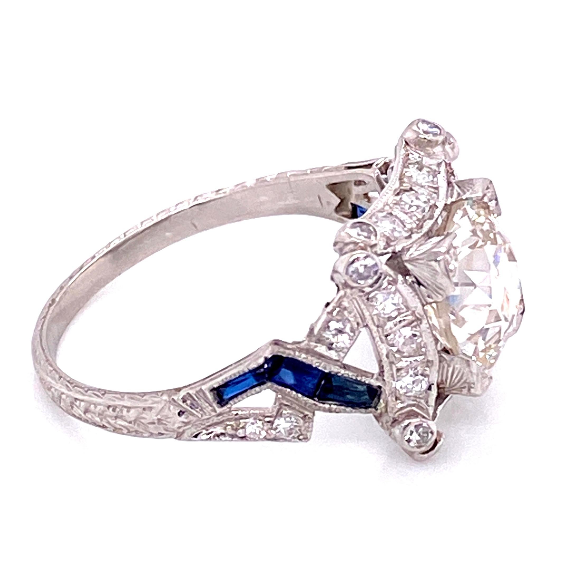 Beautiful and finely detailed Diamond and Sapphire Art Deco style Cocktail Ring, center securely set with an Old European cut Diamond weighing approx. 2.16 Carat, SI2 clarity; K color, surrounded by Diamonds weighing approx. 0.46 total carats and